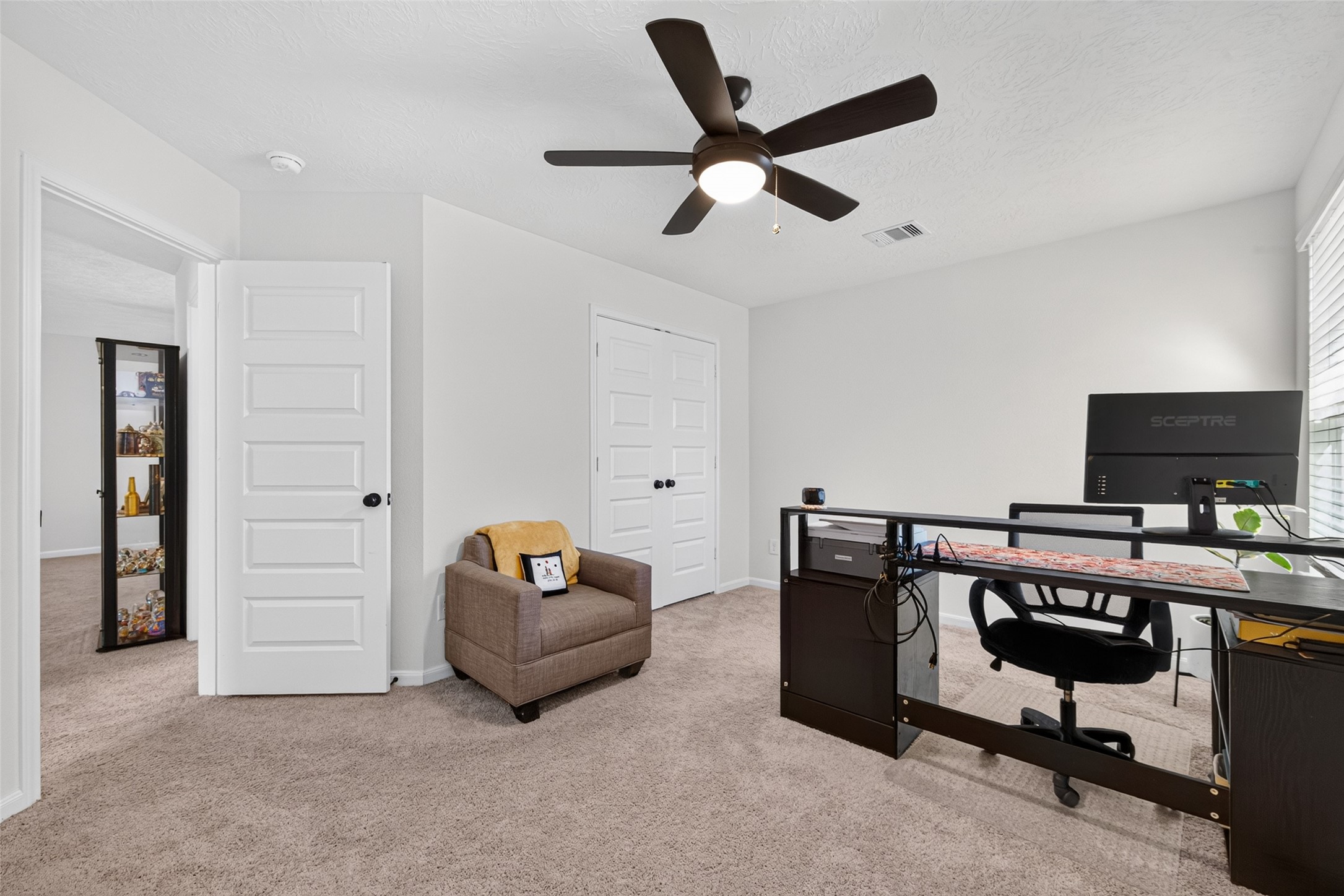 This versatile secondary bedroom is currently being used as a home office, showcasing its flexibility to accommodate your lifestyle. Whether you need a comfortable bedroom, a dedicated workspace, or a creative retreat, this space offers plenty of possibilities.