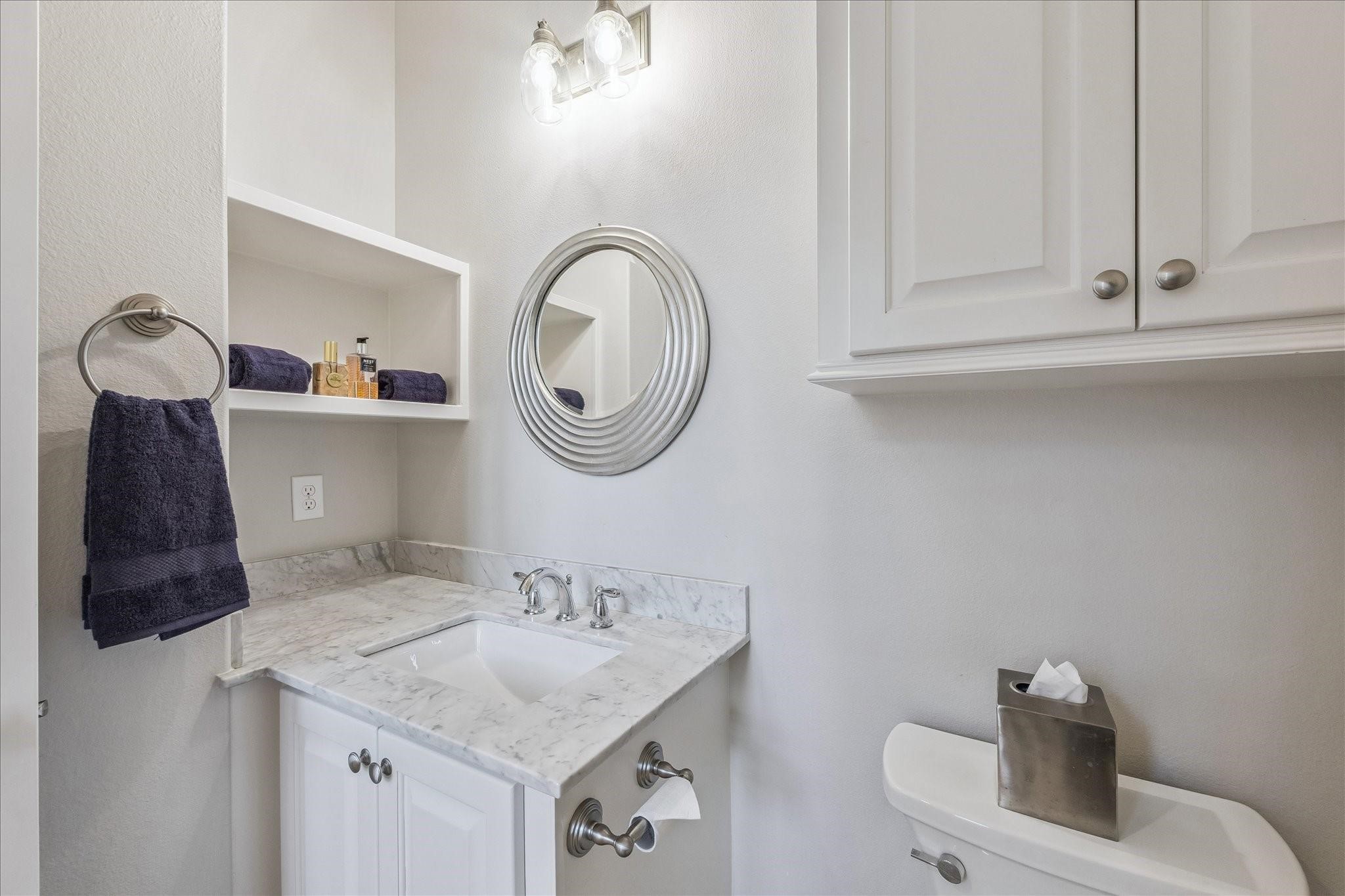 Half bath off the Great Room with under-mount sink, added storage and sleek design