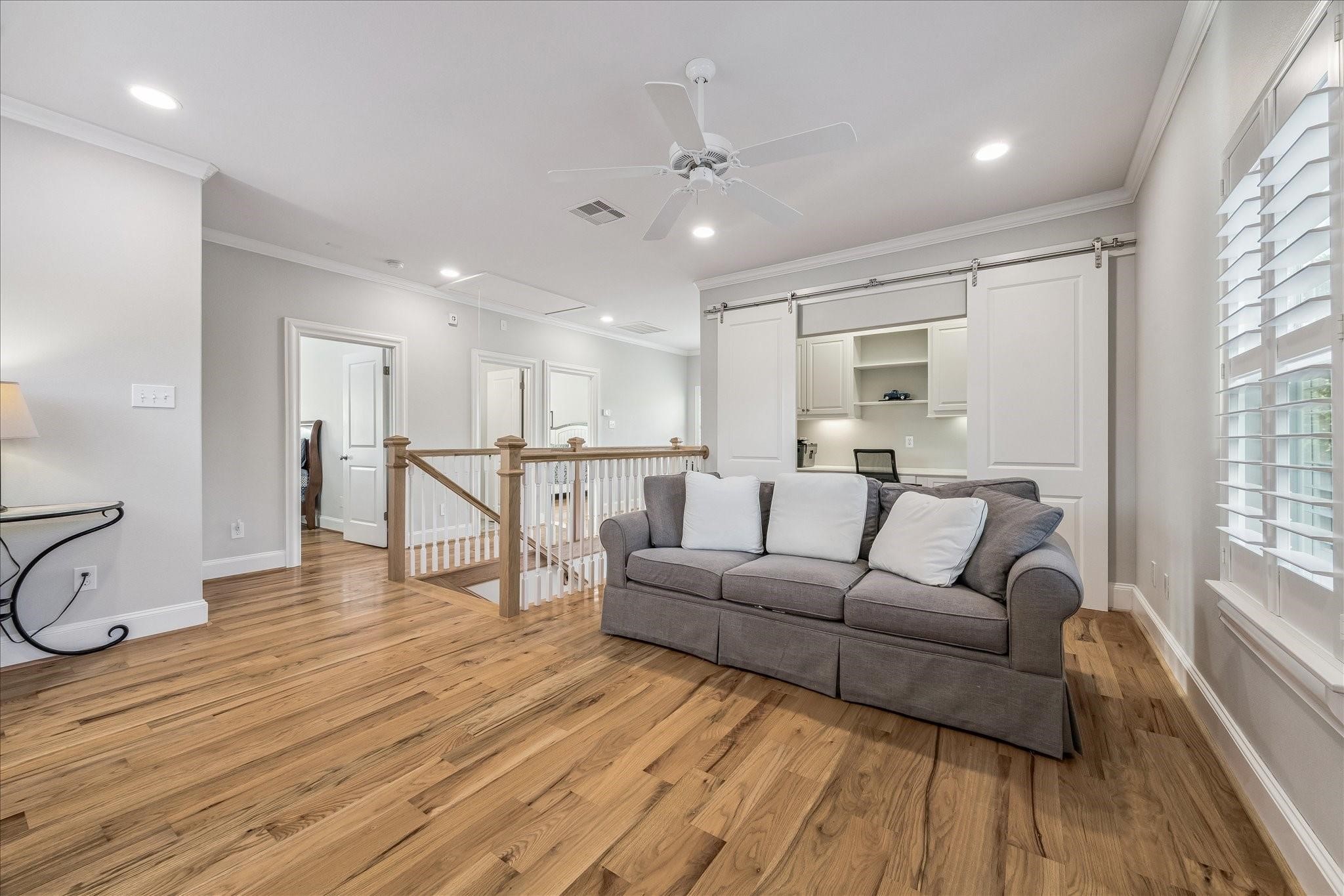 Bright and airy upstairs game room and in-home office with sliding barn doors