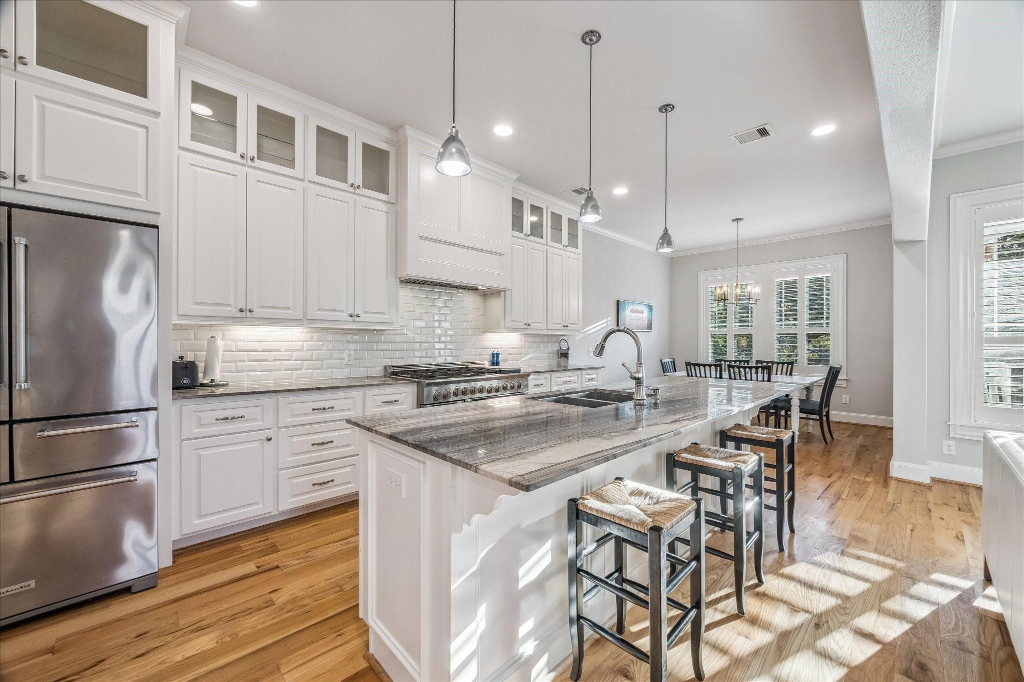 Another view of this sparkling kitchen connected to the dining area