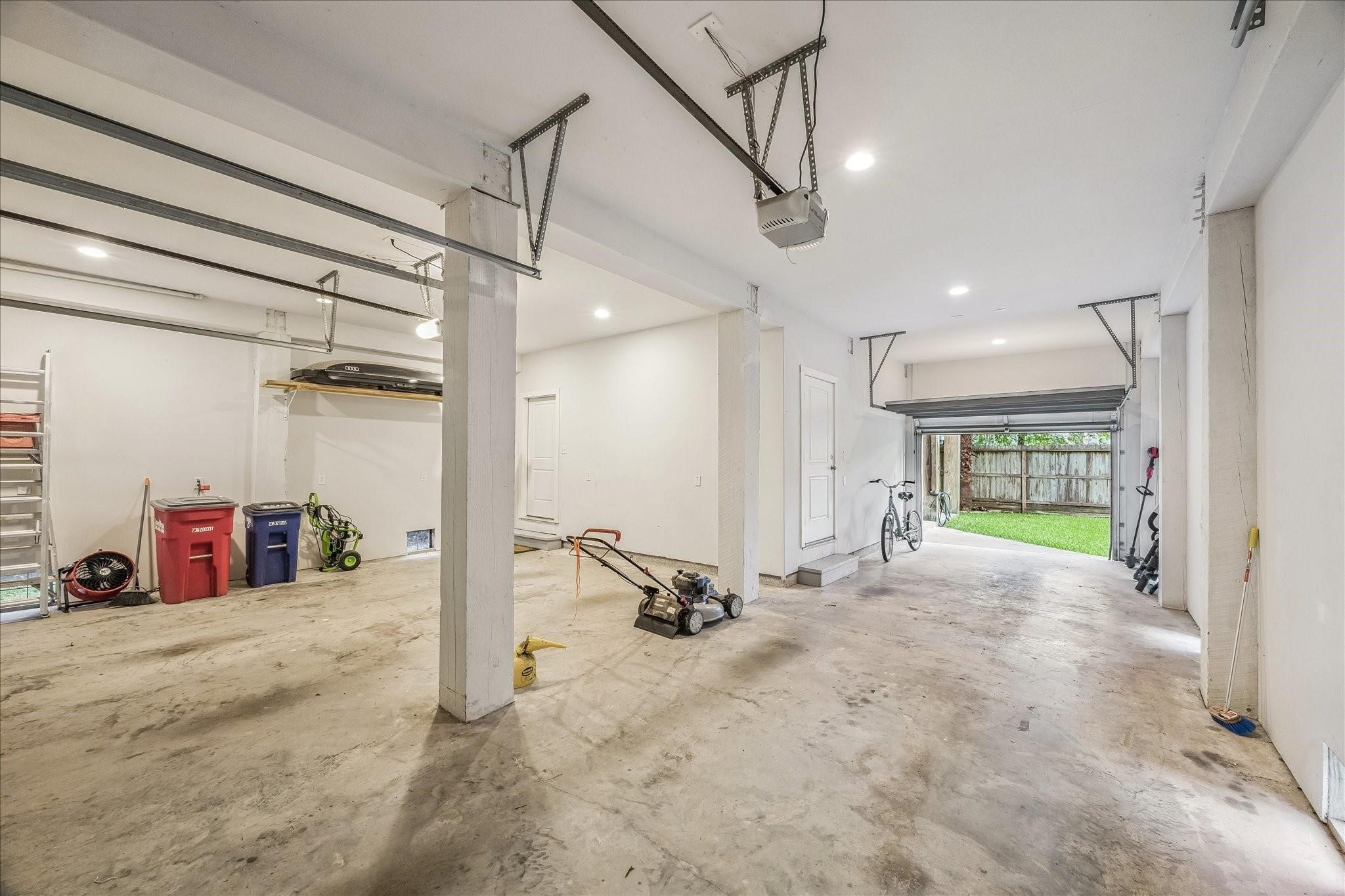 Oversize, three car tandem garage with dual overhead automatic doors. Opens to a fenced backyard for easy access and outdoor activities