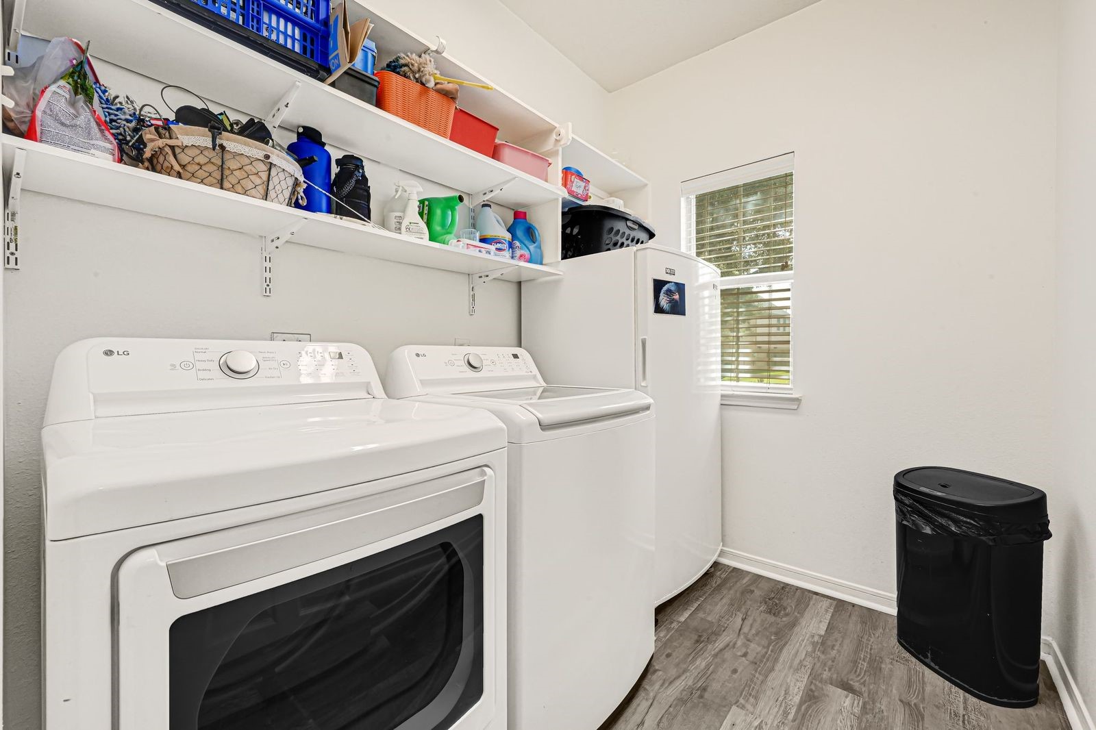 Laundry room with shelving and extra storage