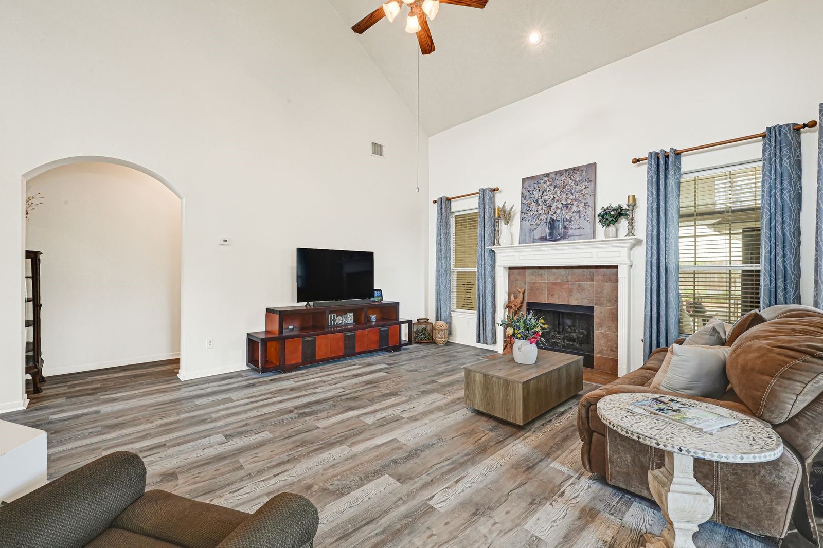 Large windows bringing in natural light. Fireplace with gas logs