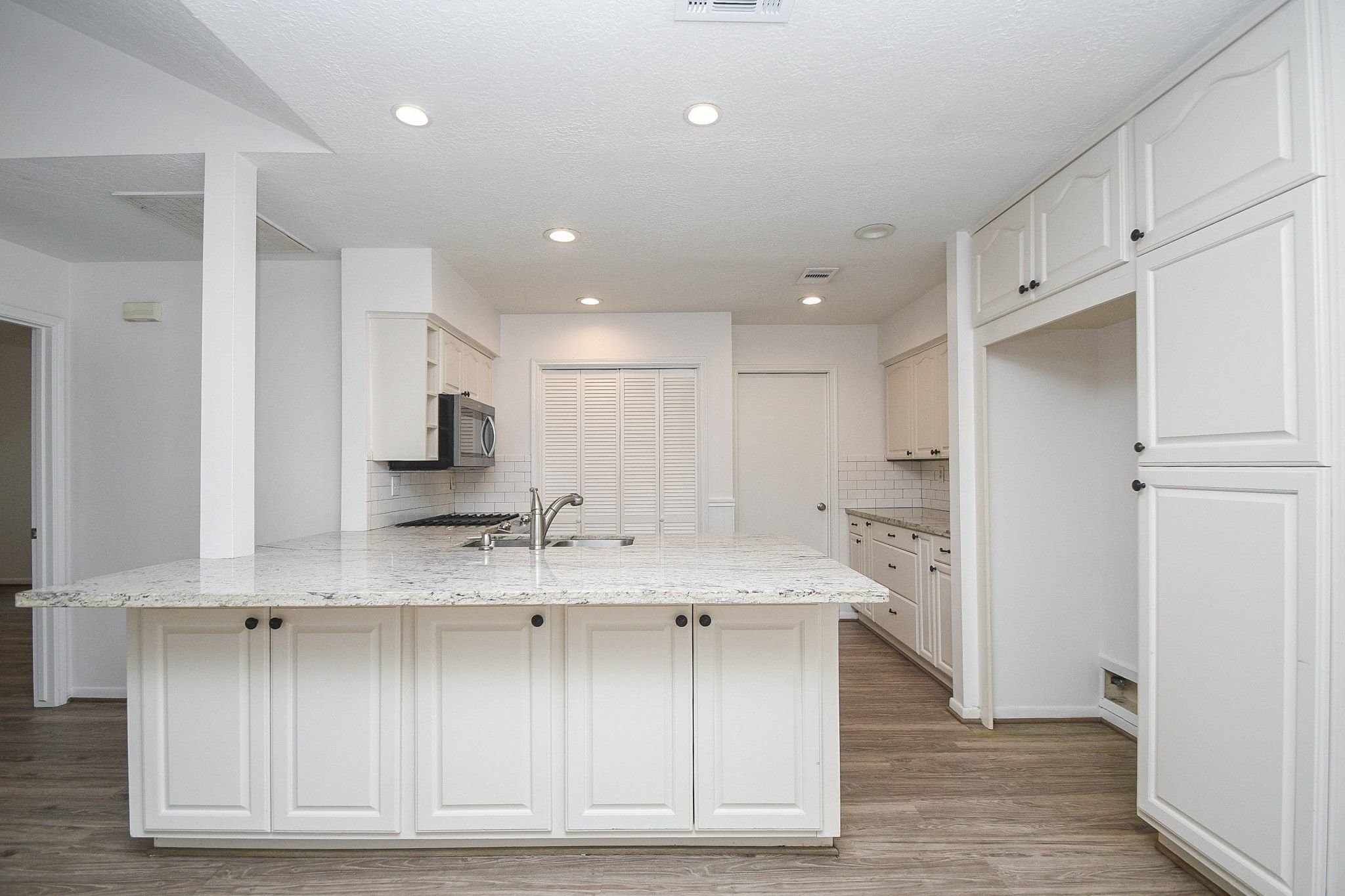 Oversized kitchen peninsula with counter seating.