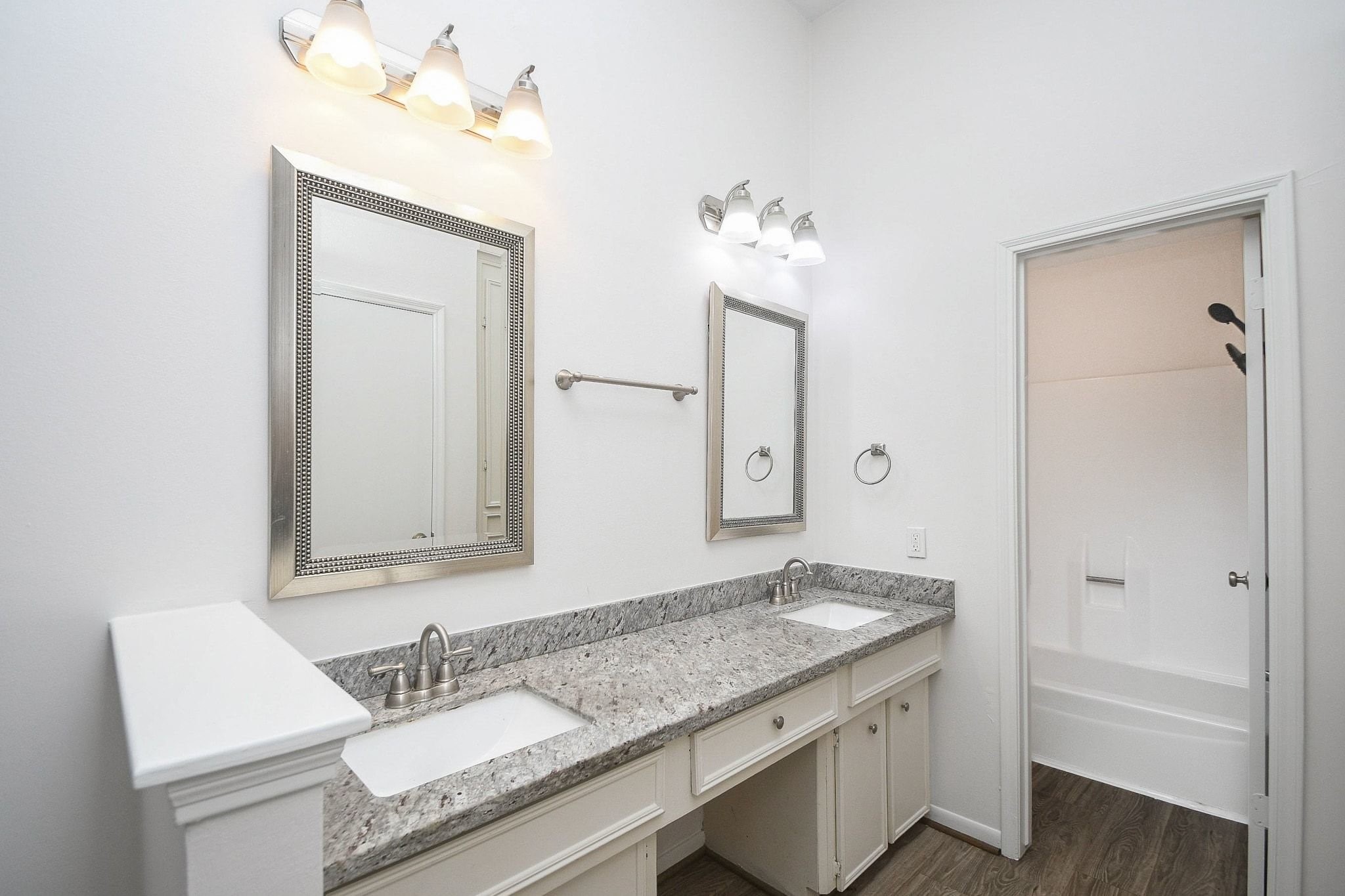 Double sinks and vanity seating area.