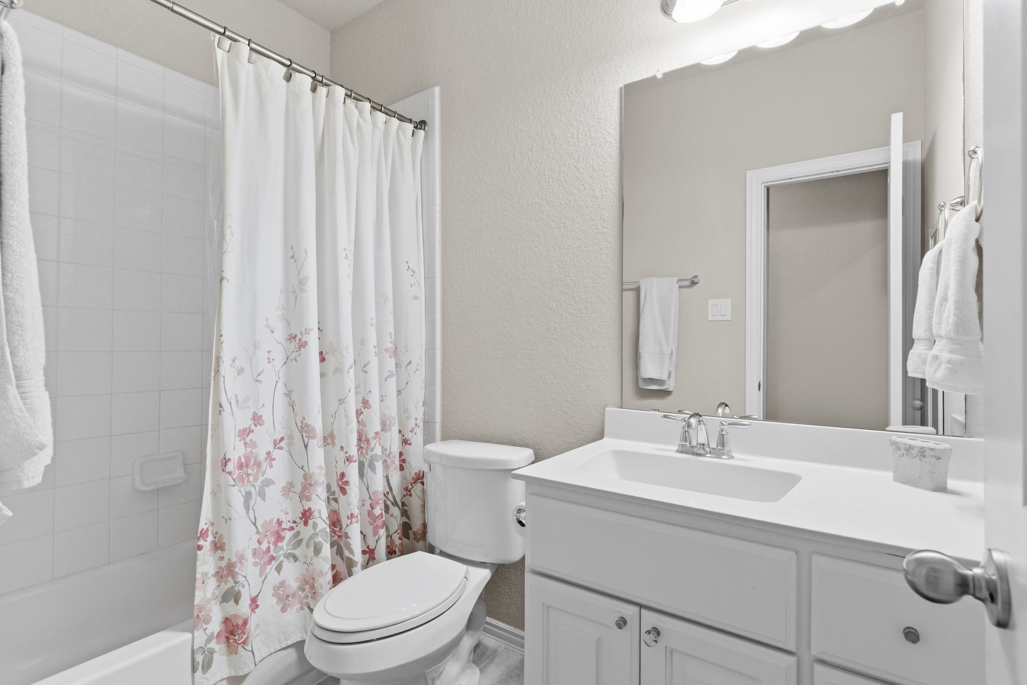 Full bath with private vanity split between two secondary bedrooms