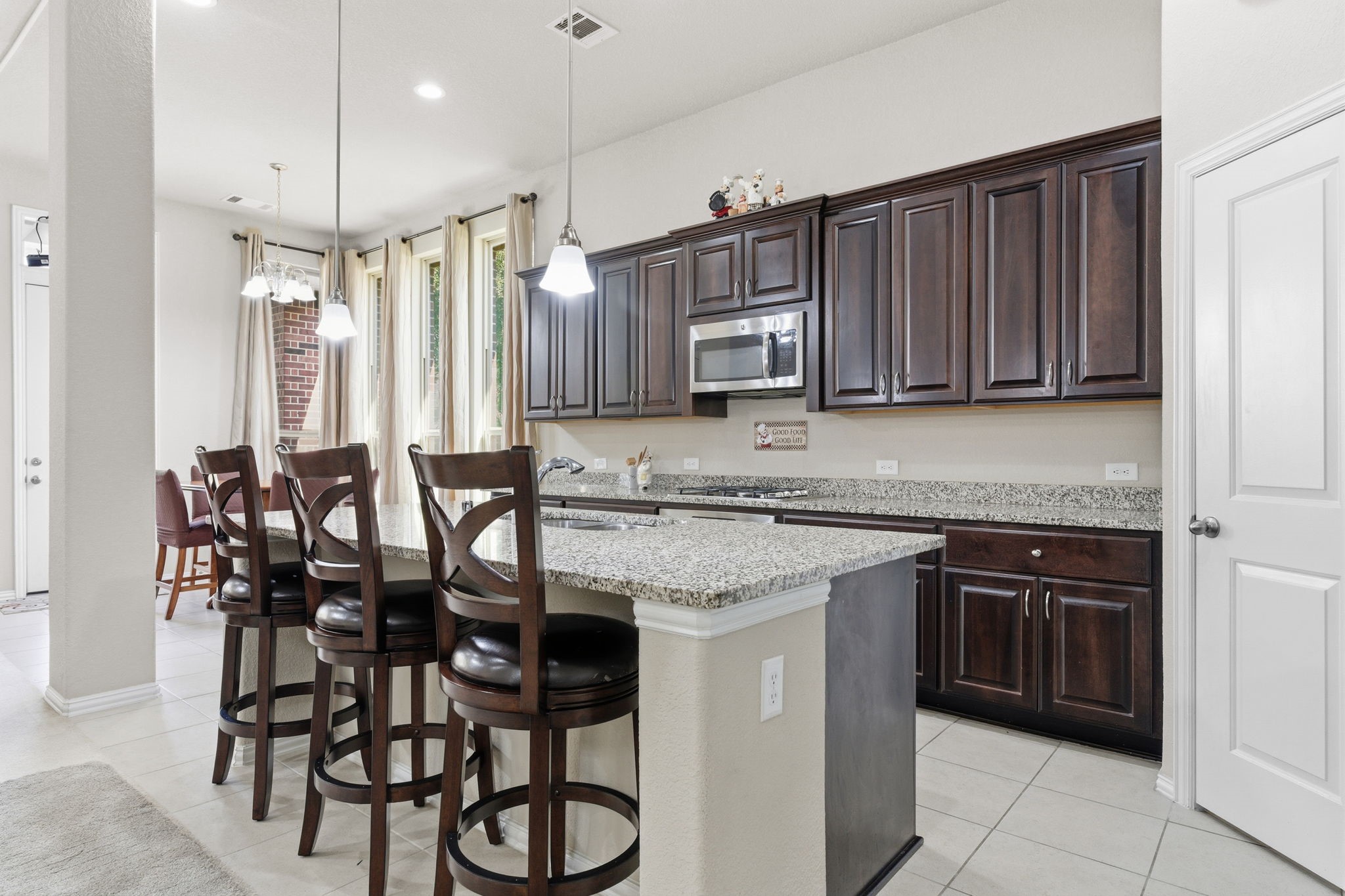 Beautiful kitchen features granite counter tops and massive kitchen island perfect for family gatherings!