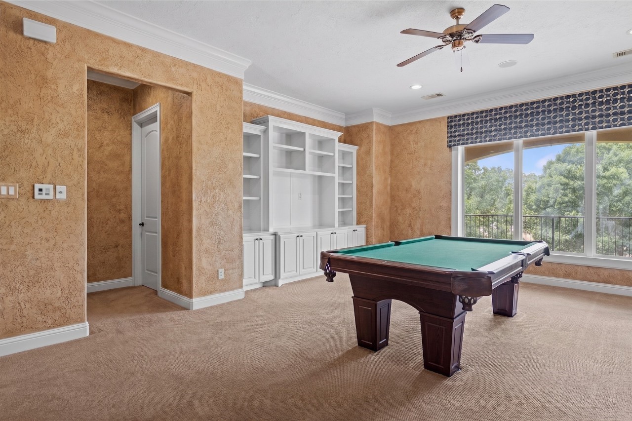 Spacious game room offering plenty of room to gather, relax, and enjoy time with family and friends.
