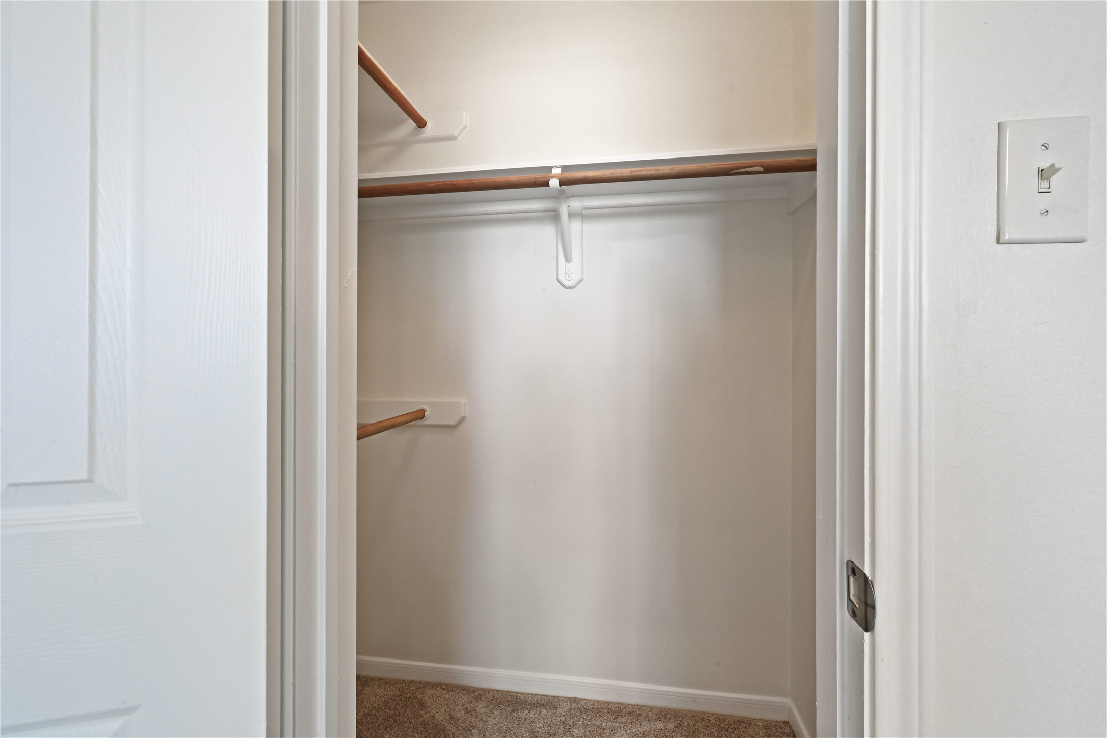Spacious walk-in closet with ample shelving and hanging space, perfect for organizing your wardrobe.