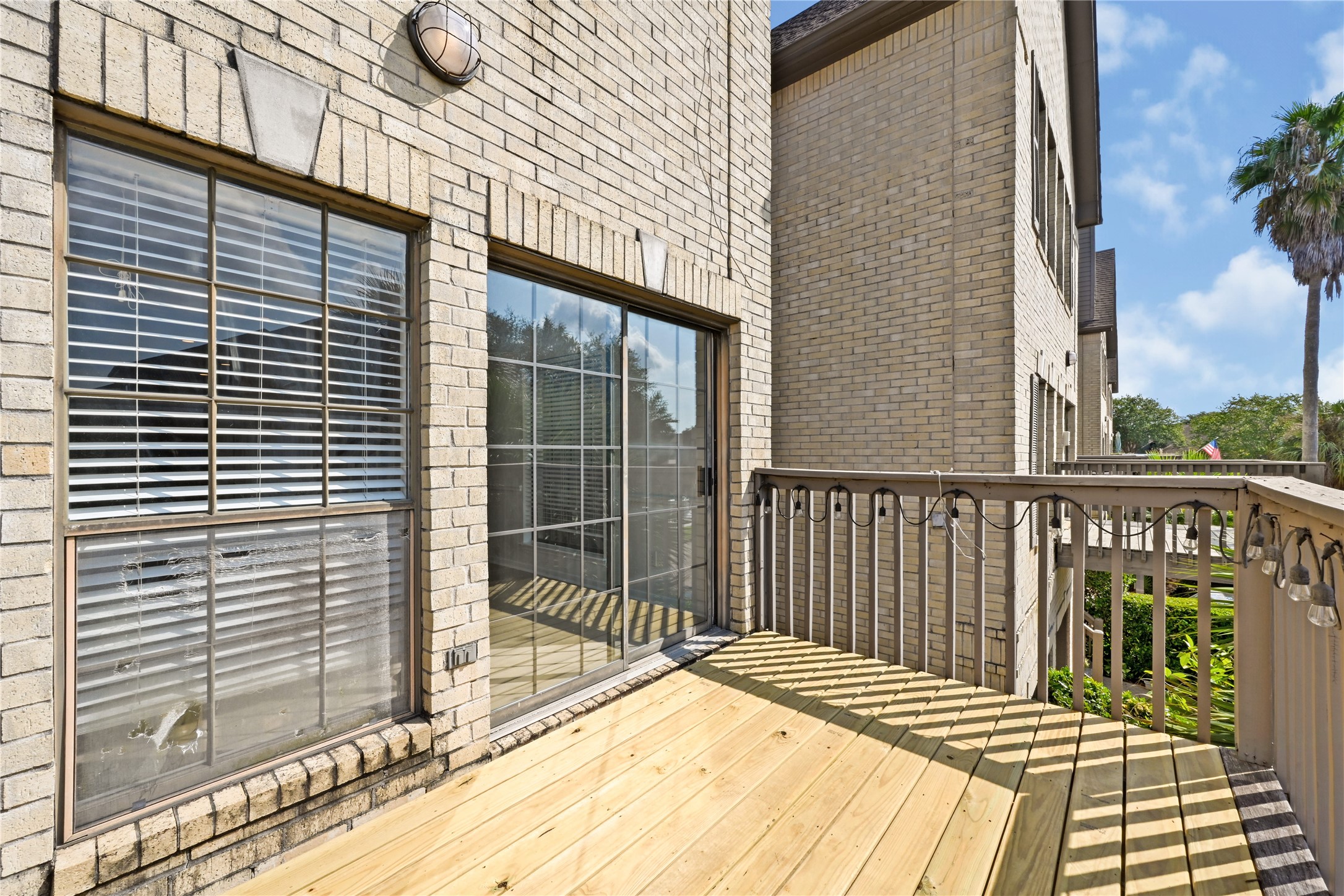 Charming deck space with a sliding glass door offers a seamless indoor-outdoor transition, perfect for relaxing and entertaining.