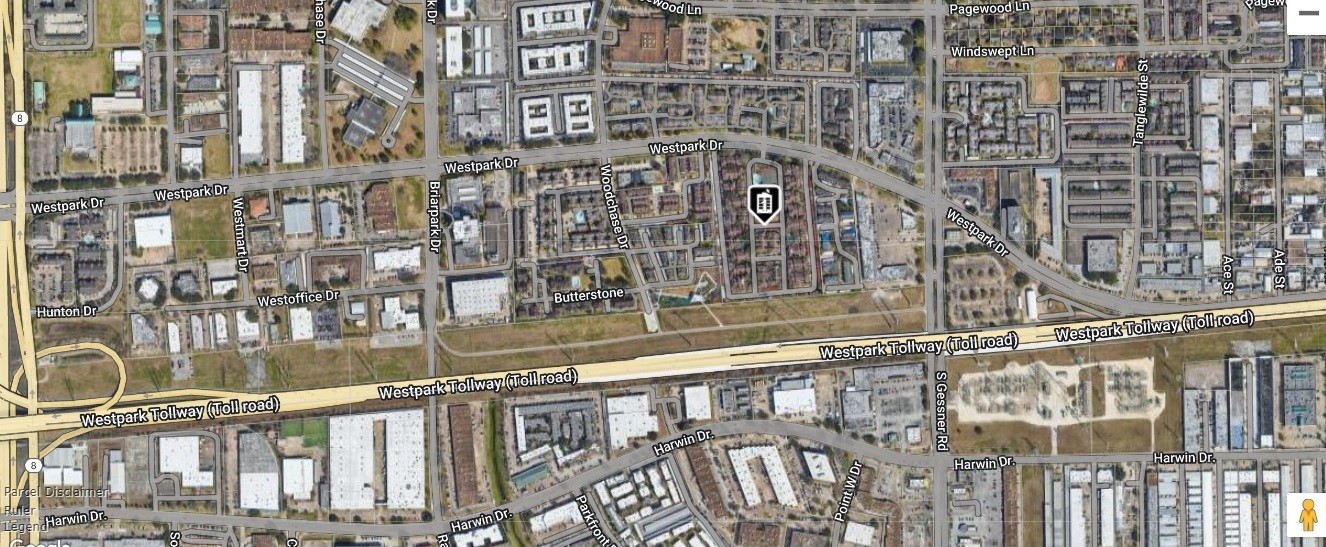 This aerial view shows a residential area with a mix of homes and commercial buildings. It's located near the Westpark Tollway, providing convenient access to major roads. The neighborhood has a grid layout with nearby amenities and green spaces.