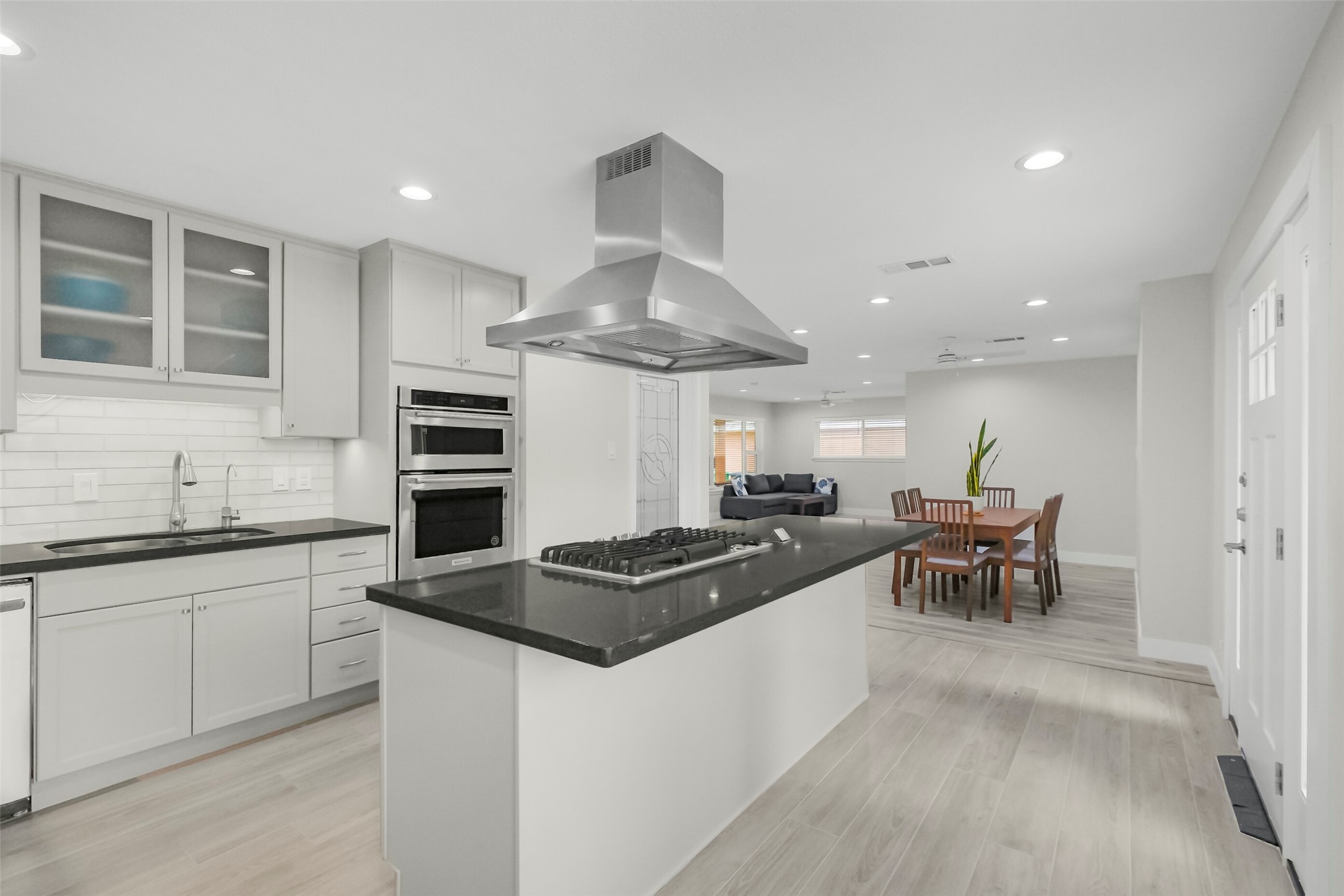 Secondary view of the kitchen shows the sitting space along the island and the dining room. Secondary view of the kitchen shows the sitting space along the island and the dining room.