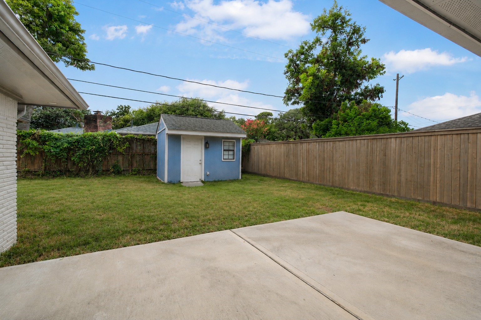 As you enter the backyard you'll notice an oversized patio space. The air conditioned unit makes a a great flex space. (Studio, storage, weight room, play room etc)