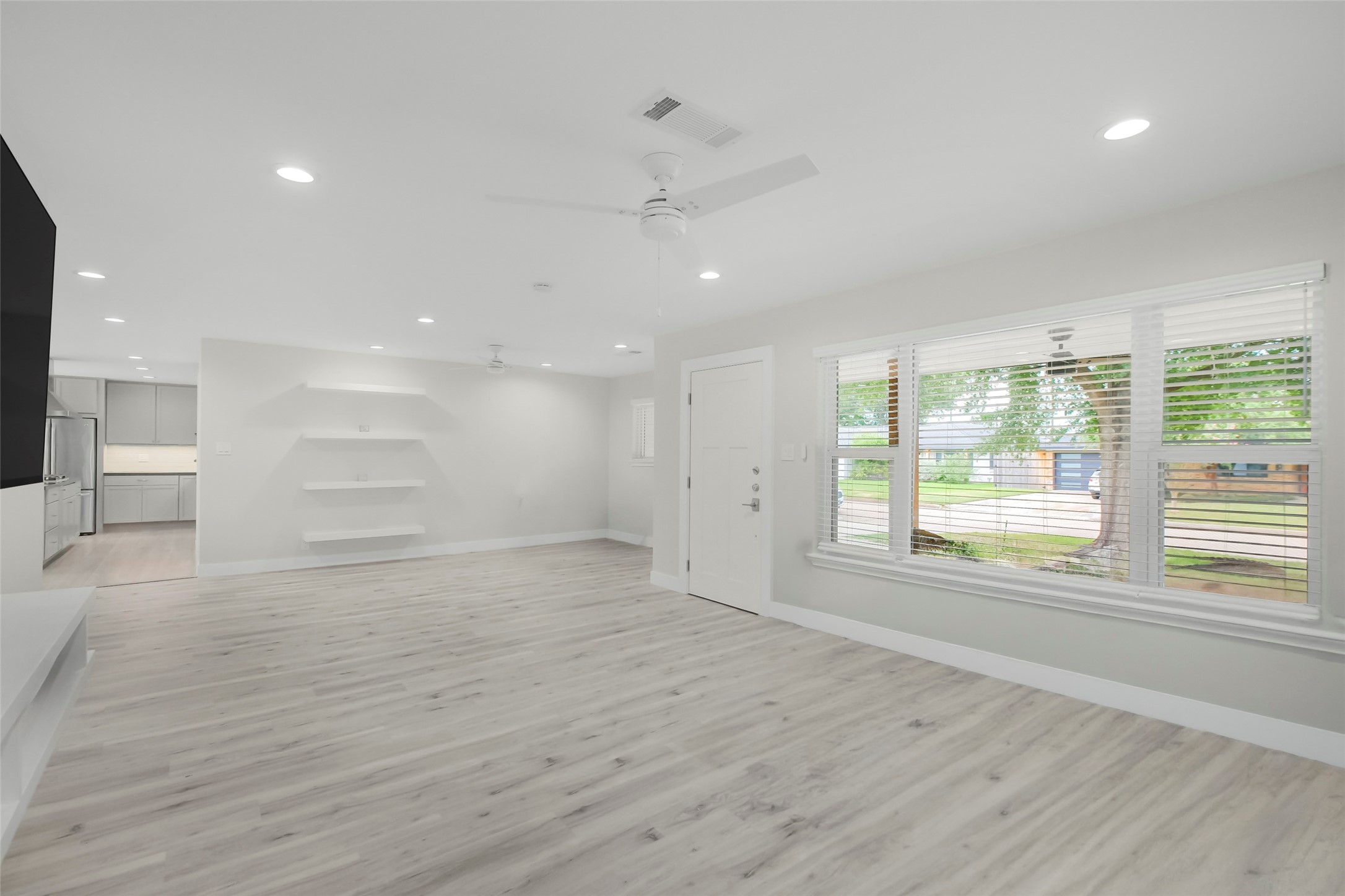 Open concept living space as you enter the front door. Floating shelves and flex space currently used as home office. Open concept living space as you enter the front door. Floating shelves and flex space currently used as home office.