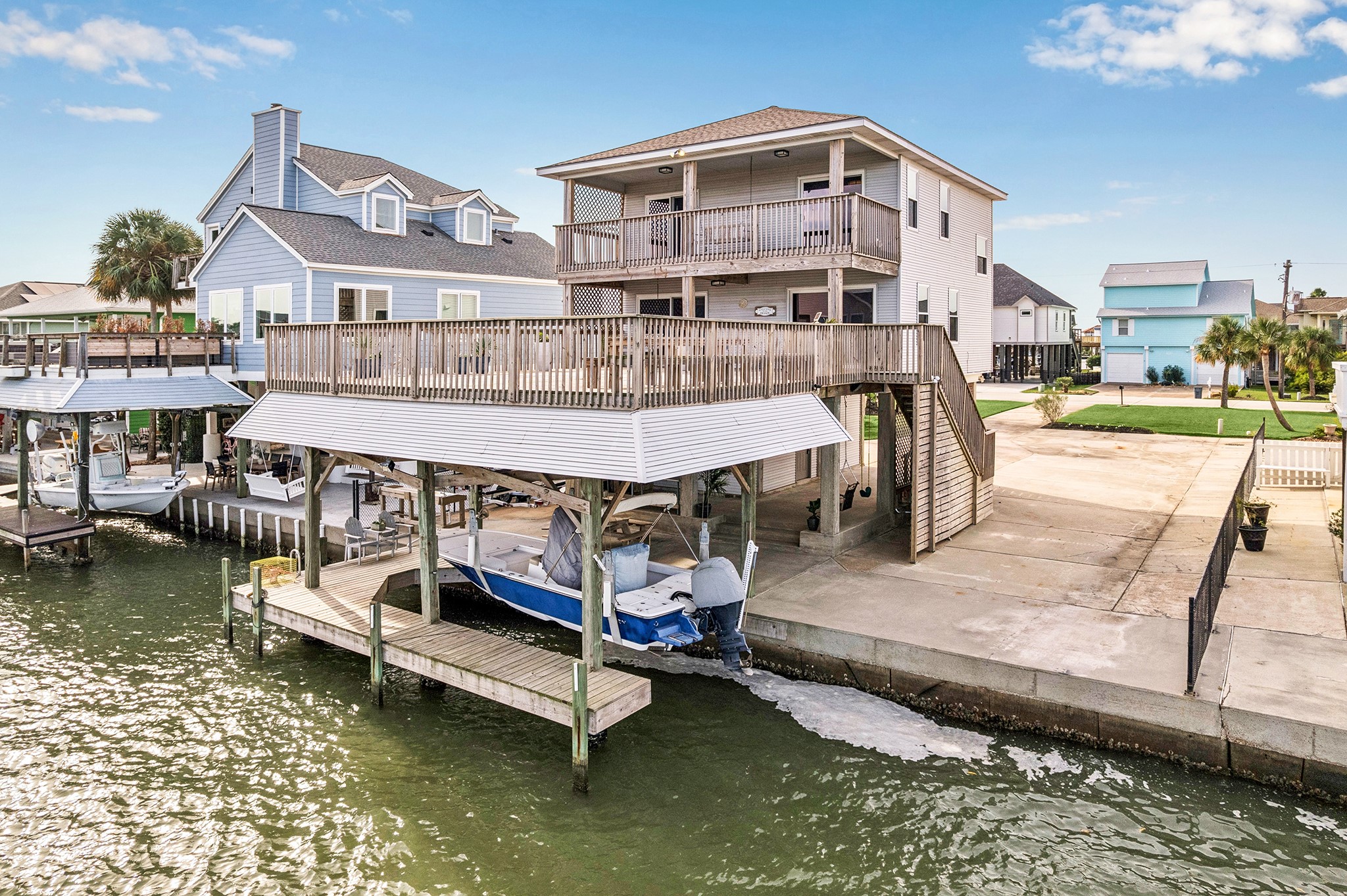 Experience waterfront living at its finest in this stunning boat house, featuring expansive decks, direct water access, and breathtaking viewsperfect for the avid boater and entertainer.