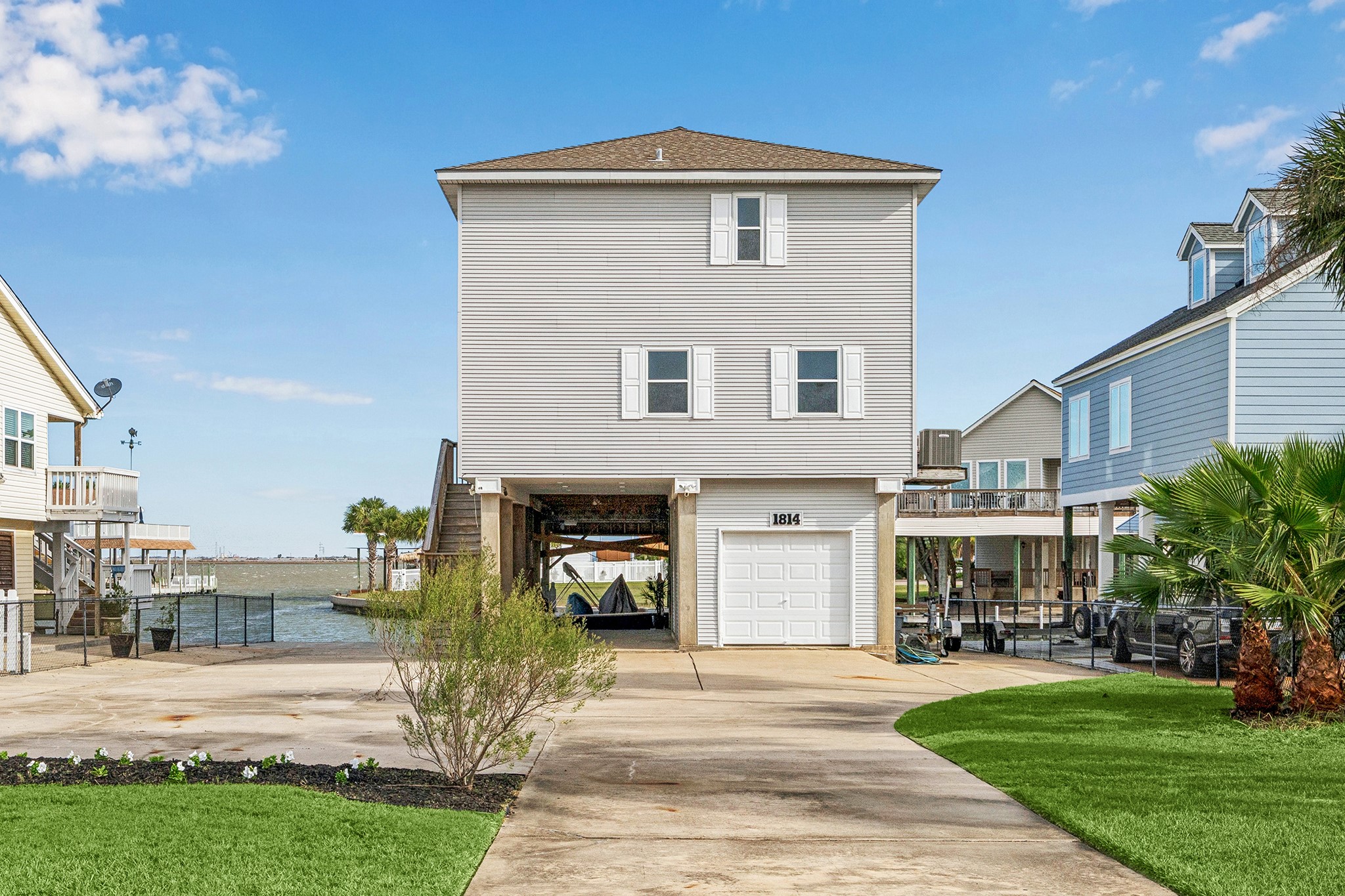 Discover the perfect balance of coastal living and modern comfort in this stunning bayview home, featuring a sleek facade, ample parking, and direct water access, promising endless relaxation and adventure.