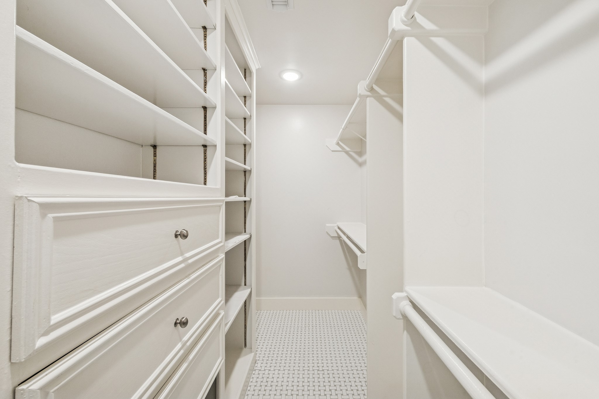 Step into the spacious primary closet, where custom shelving and ample hanging space turn organization into a luxurious experience.