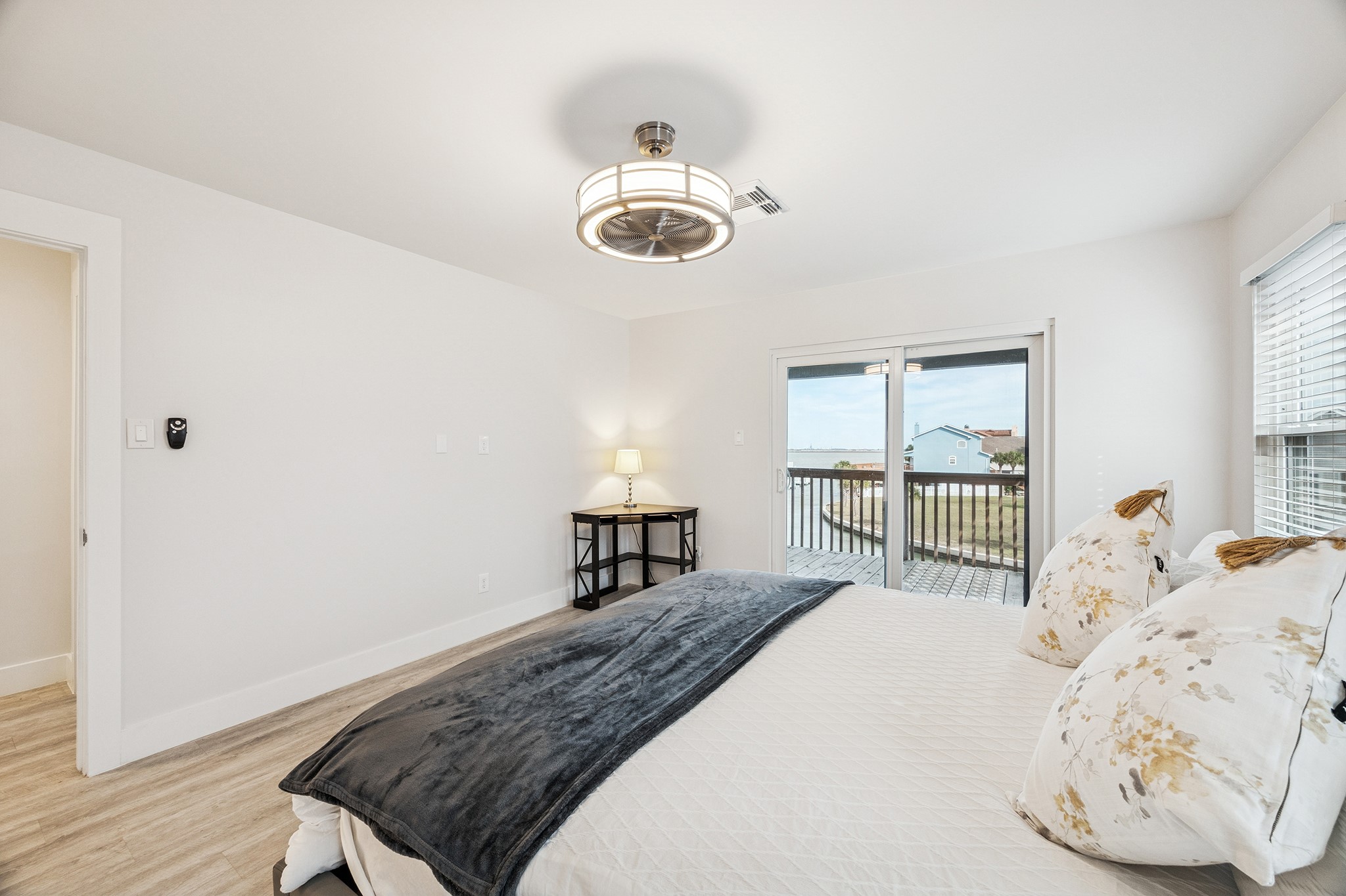 Discover tranquility in this spacious primary bedroom, featuring elegant hardwood floors, abundant natural light, and direct access to a serene balcony with picturesque views.