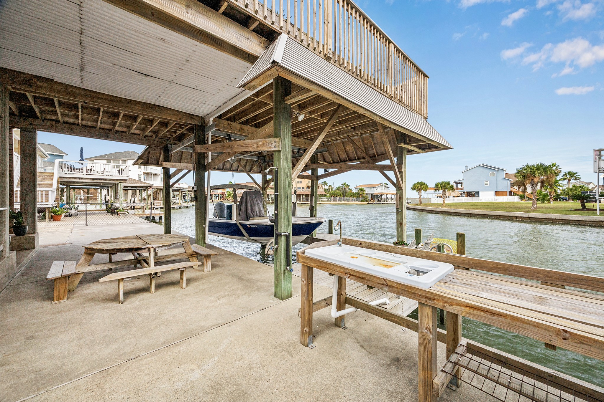Experience waterfront living with this charming boat house and convenient fish cleaning station, perfect for the avid angler and outdoor enthusiast.