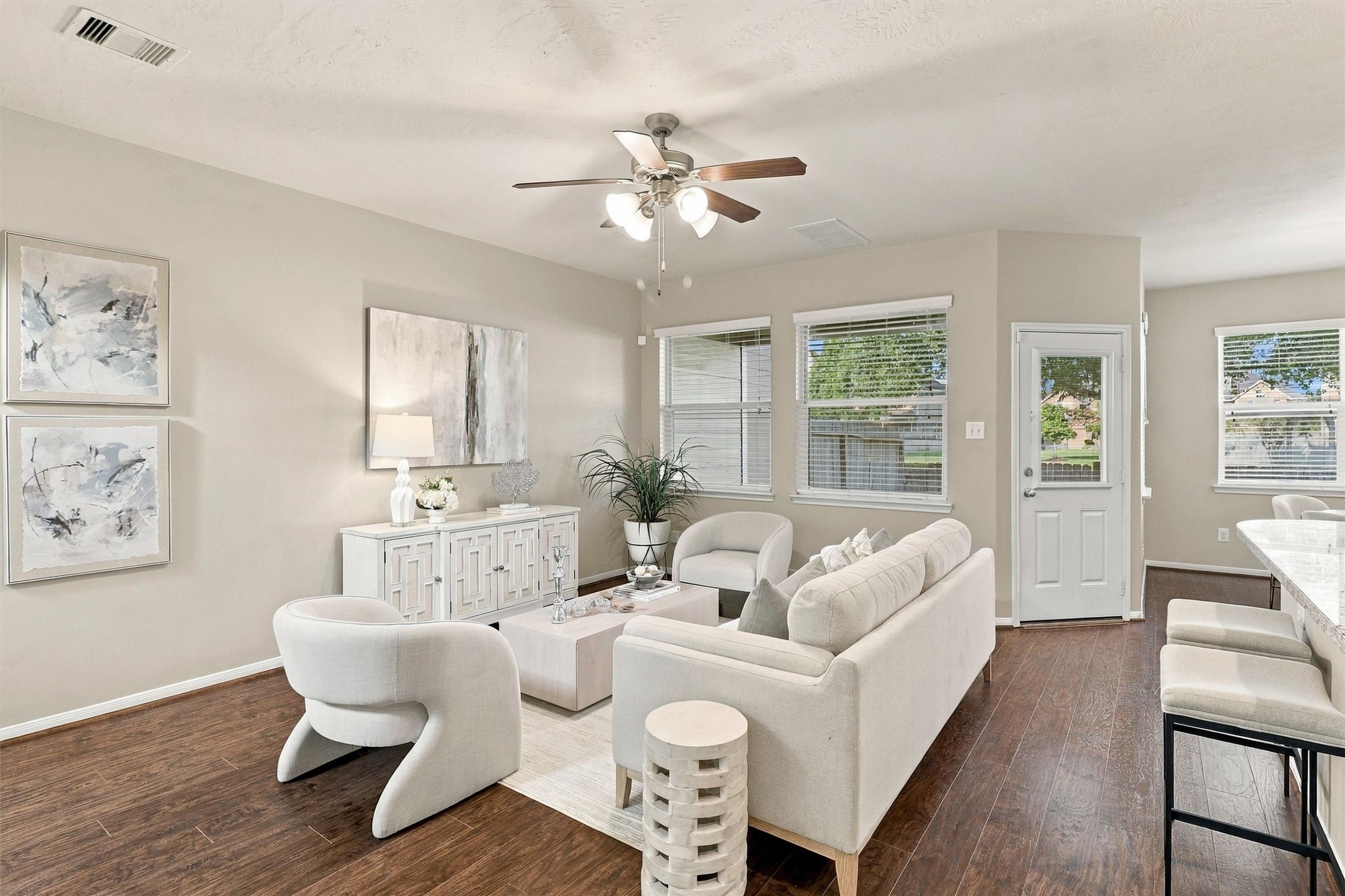 Meticulously maintained, this 2-story townhome features refreshed interior paint (2026), NEW carpet in the bedrooms (2026), cohesive wood-look flooring throughout the 1st floor, elegant lighting, crisp white kitchen cabinets, and updated half-bath tile.