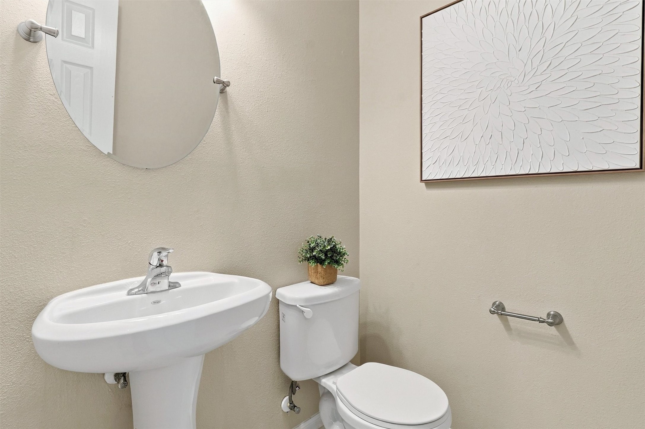The glittering half bath has been updated with hexagonal marble-look tile, a frameless mirror with brushed nickel finishes, updated lighting, and Sherwin Williams paint! It's another pocket of little luxuries!