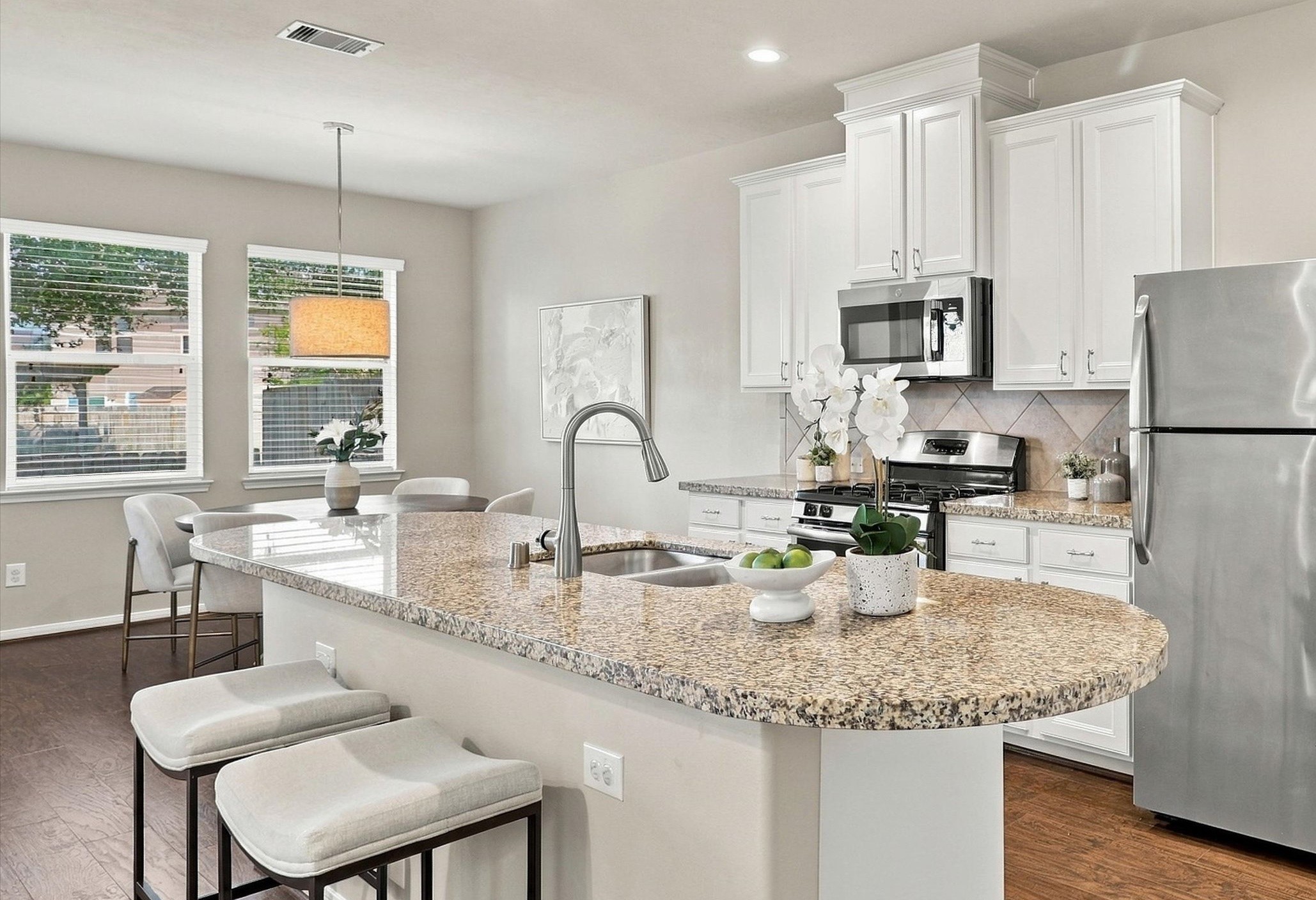 This pristine townhome features 3 beds, 2.5 baths, 2-car garage, and a flex space!