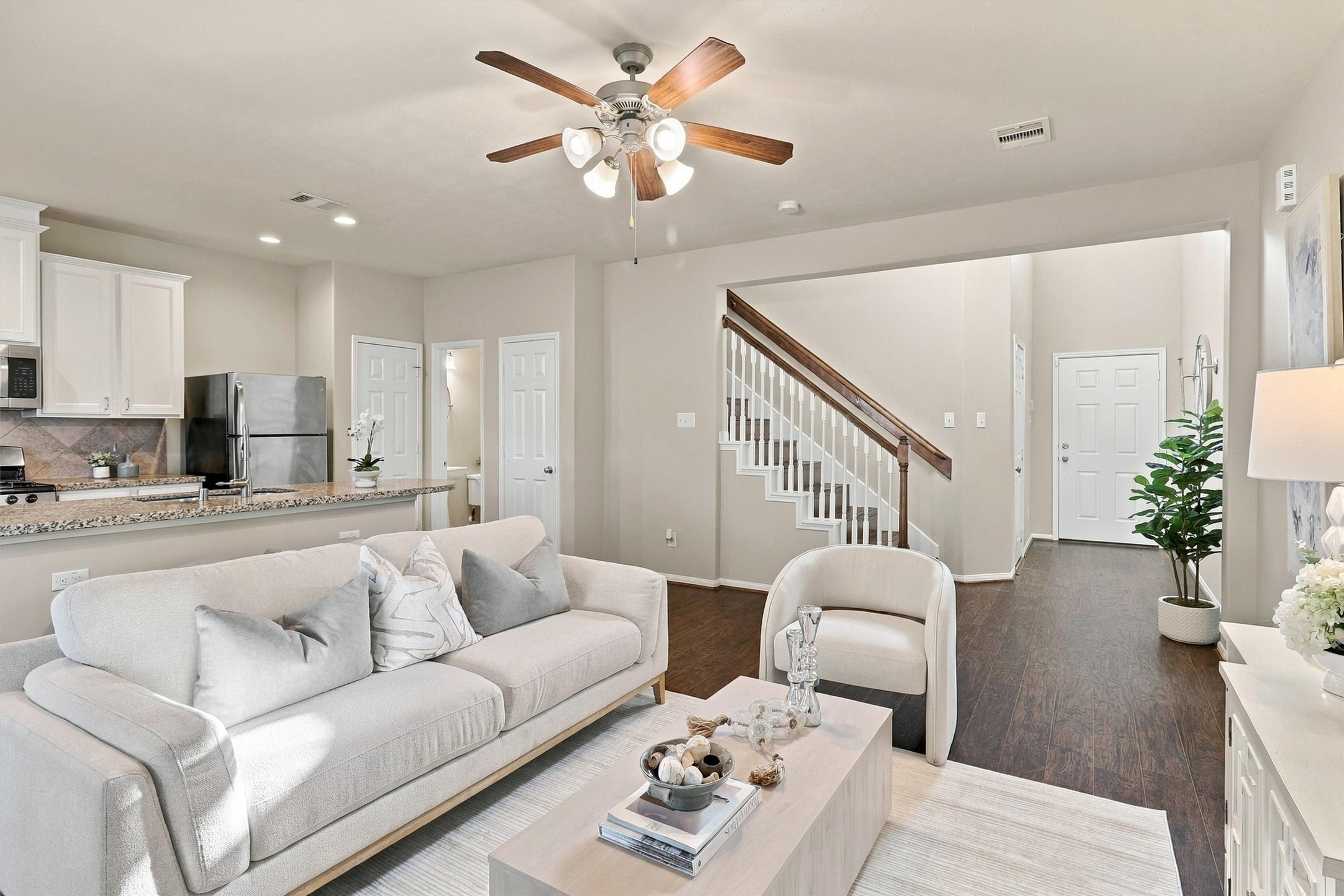 This view of the living room highlights the open concept floor plan.  The kitchen is just behind the living room, along with the half-bathroom and massive storage closet that winds under the staircase.