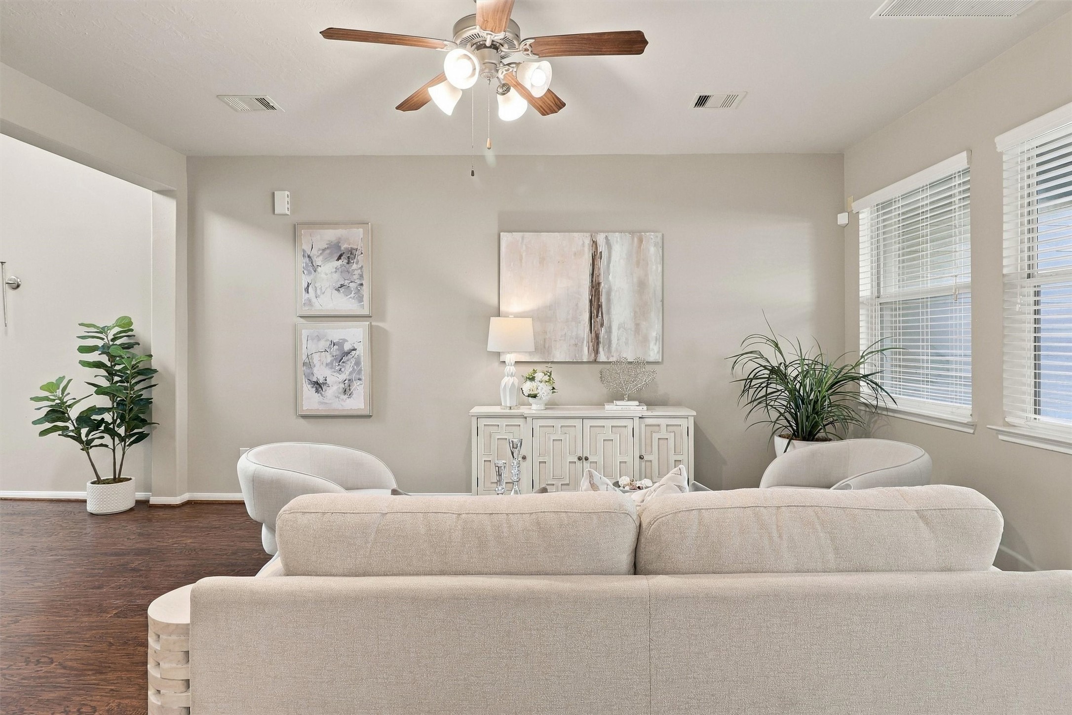 View from the kitchen highlights the space inside your living room.  Single-story ceilings, double pane windows, and ceiling fan keep energy costs low.