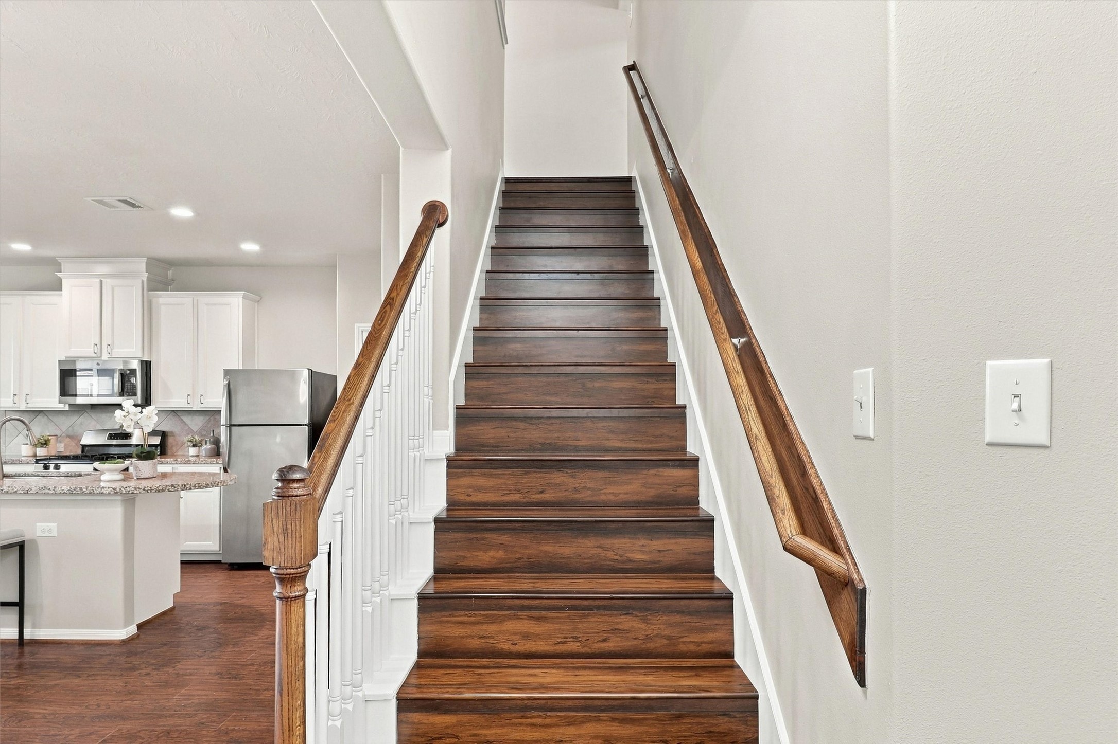 Travel upstairs to find 3 bedrooms, 2 full baths, a game room and laundry area!  Note the elevated treads and risers with crisp white trim and balusters!