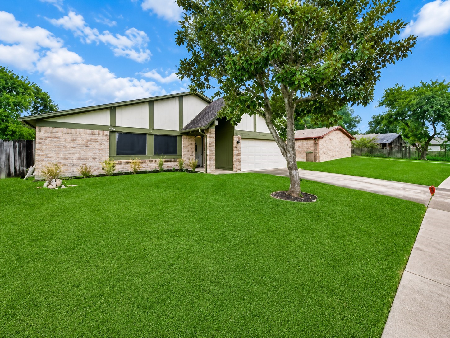 Spacious front yard with mature landscaping, offering another view of the homes exterior and attached two-car garage. Spacious front yard with mature landscaping, offering another view of the homes exterior and attached two-car garage.