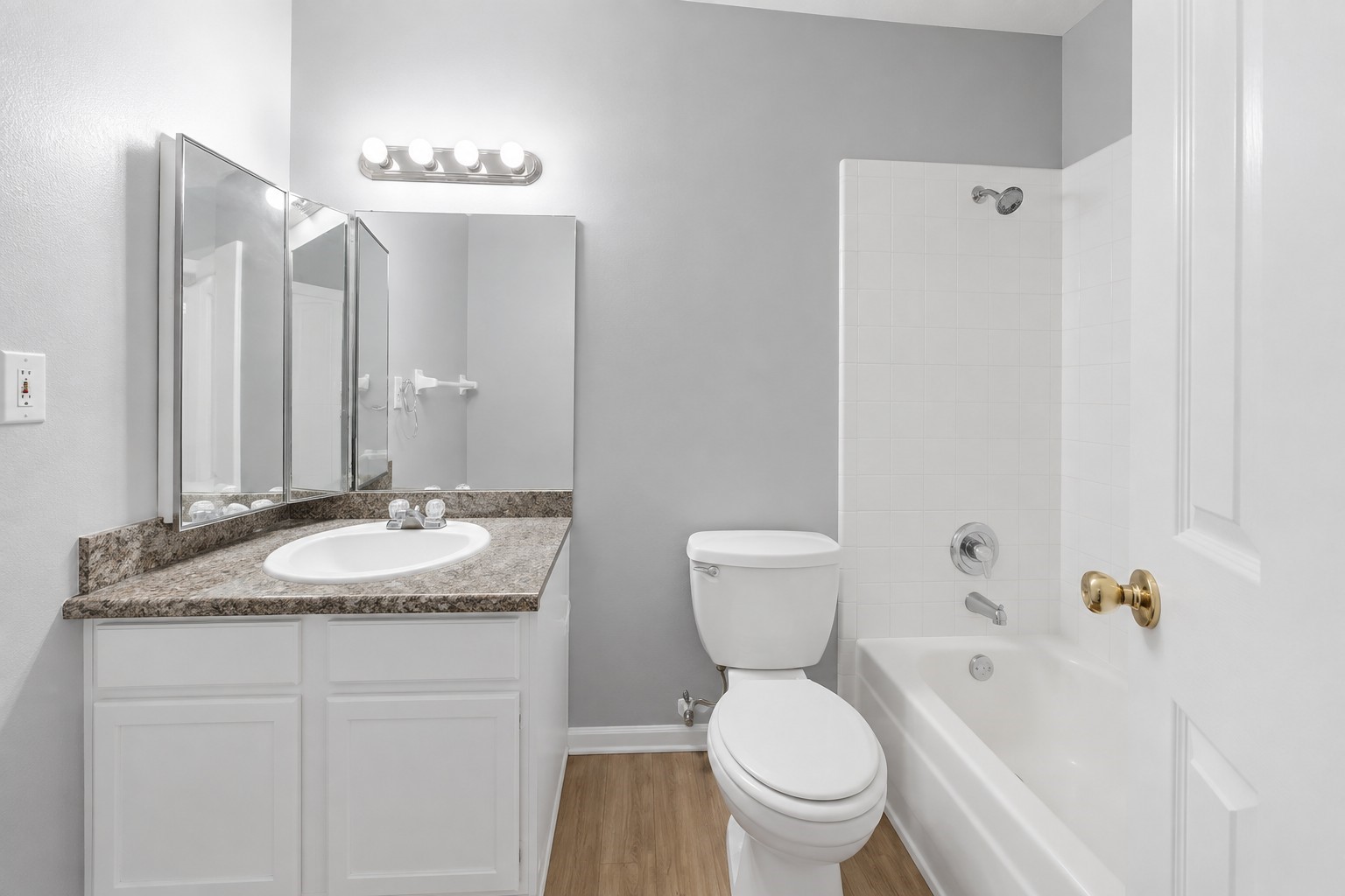 Private primary ensuite bathroom featuring a vanity and tub/shower combination.