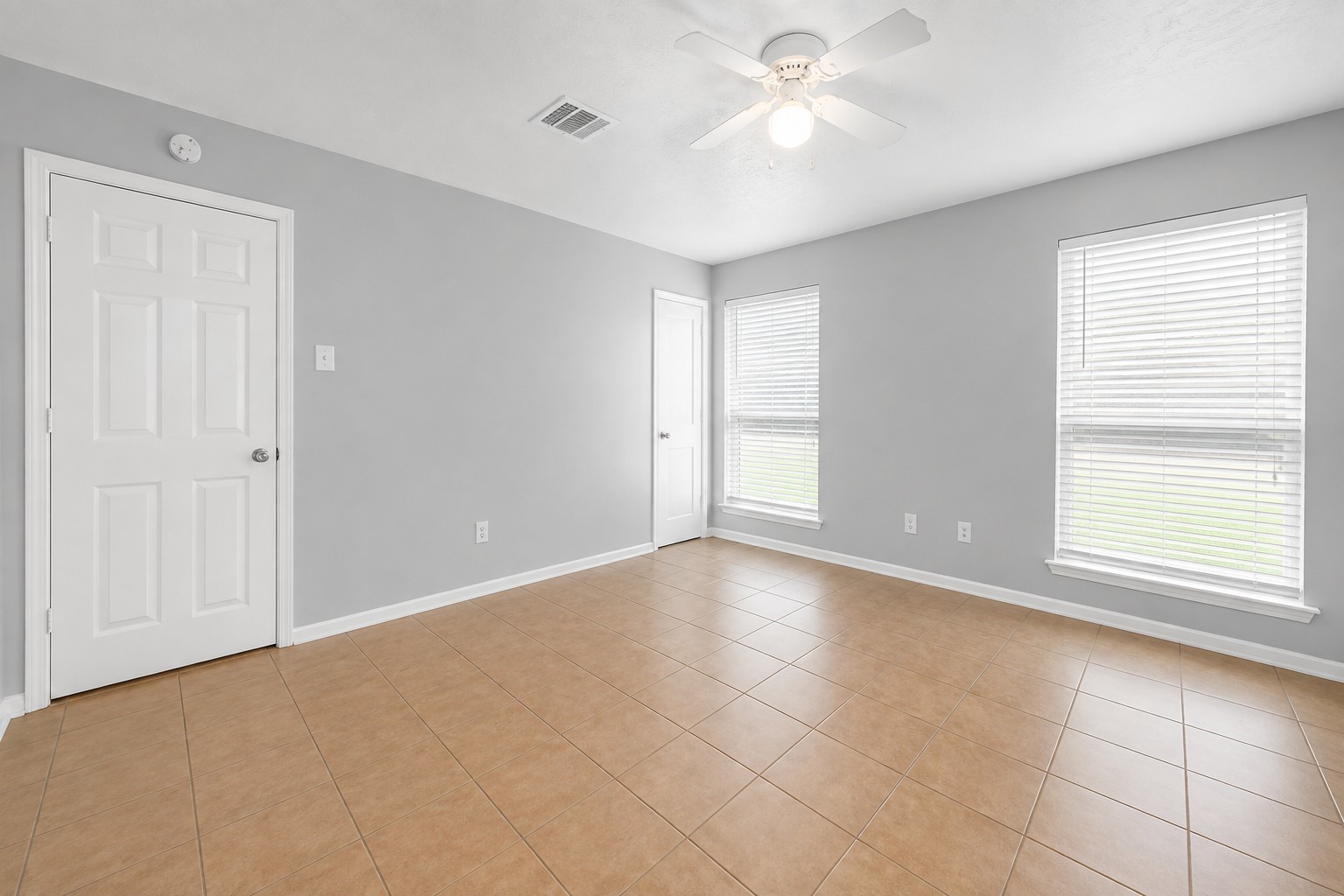 Another view of the primary bedroom with convenient access to the private ensuite bathroom.
