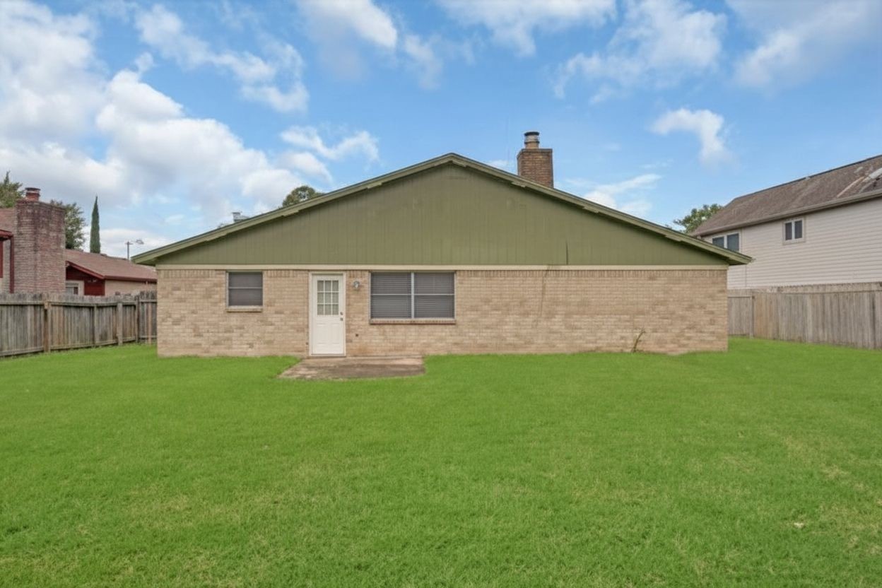 Expansive fenced backyard with plenty of open green space for outdoor enjoyment.