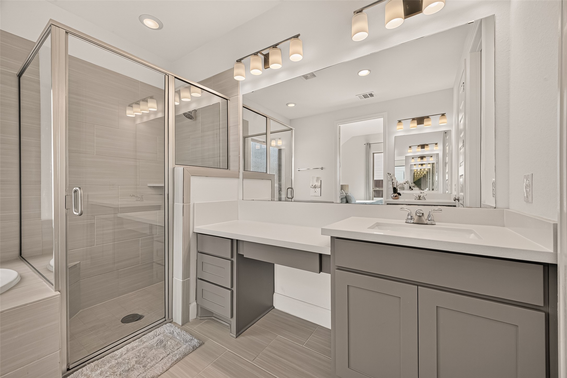 The separated shower and tub provide versatility and convenience, while the separate double sink cabinets with lots of storage space offers functionality without compromising on style.