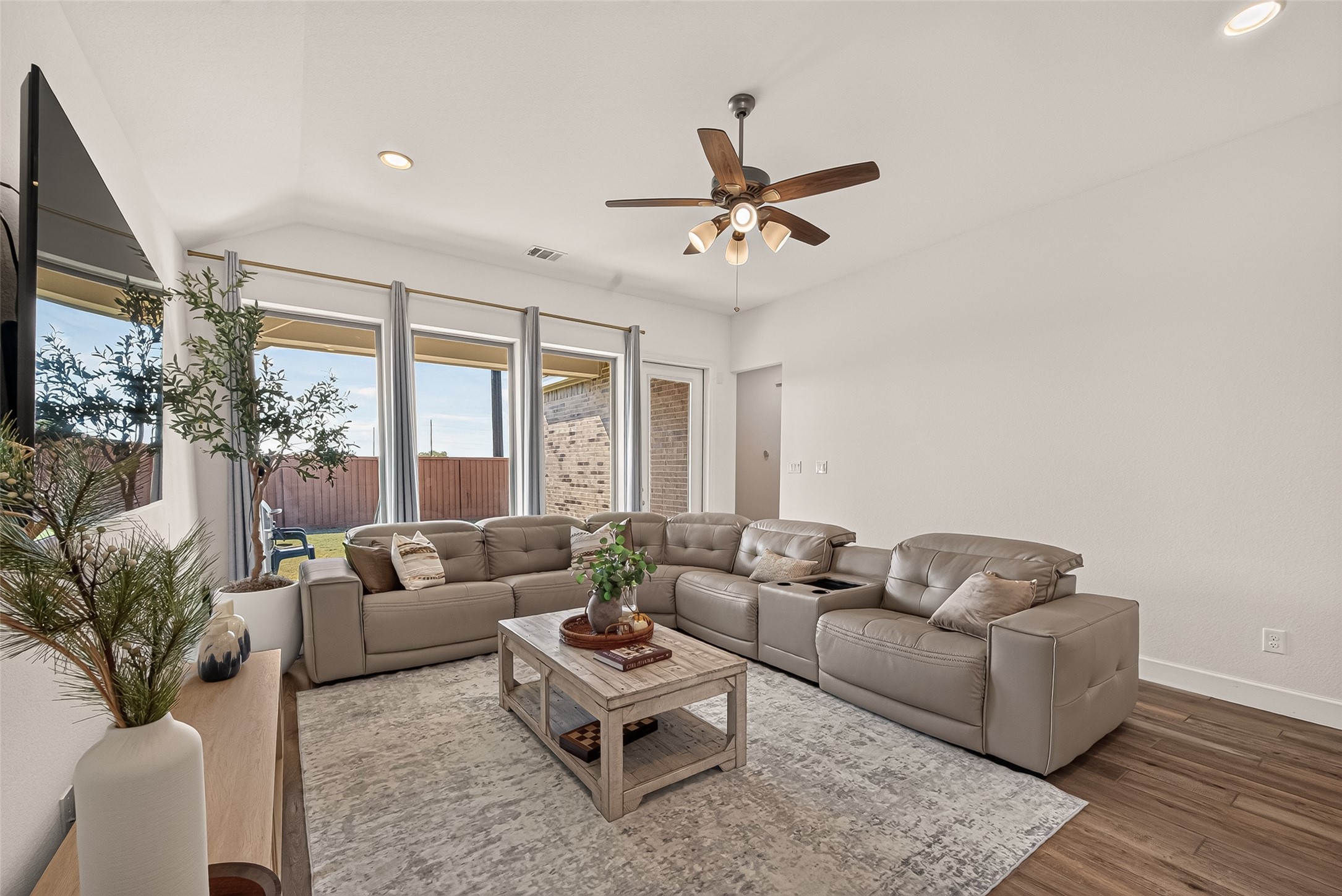 Natural light floods through the windows, creating a bright and airy atmosphere in the living room, perfect for enjoyment with family and guests!