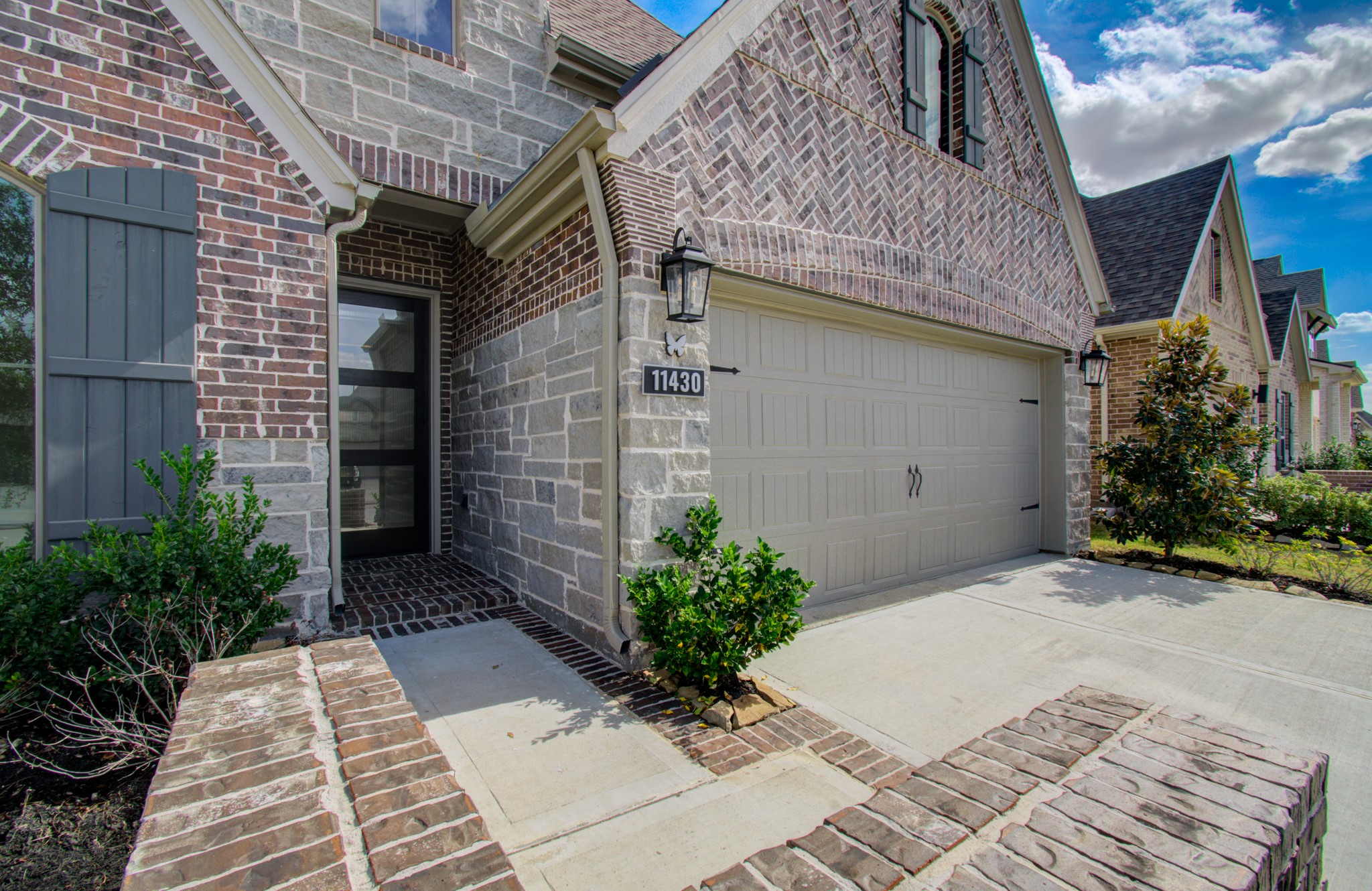 Welcoming entryway with a beautiful brick-outlined walkway.
