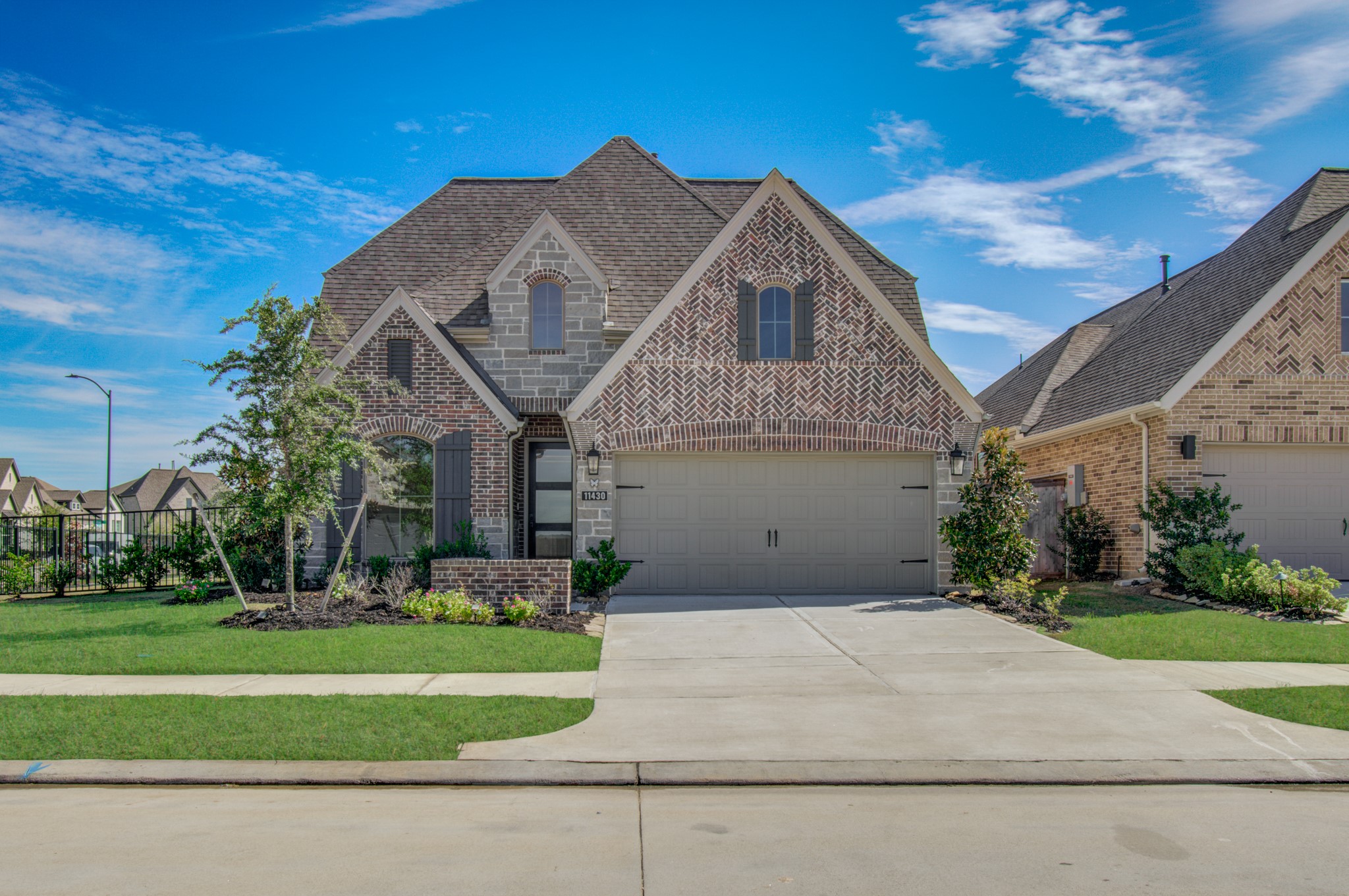 Perry home with brick and stone accents with a two-car garage and beautifully landscaped front yard.