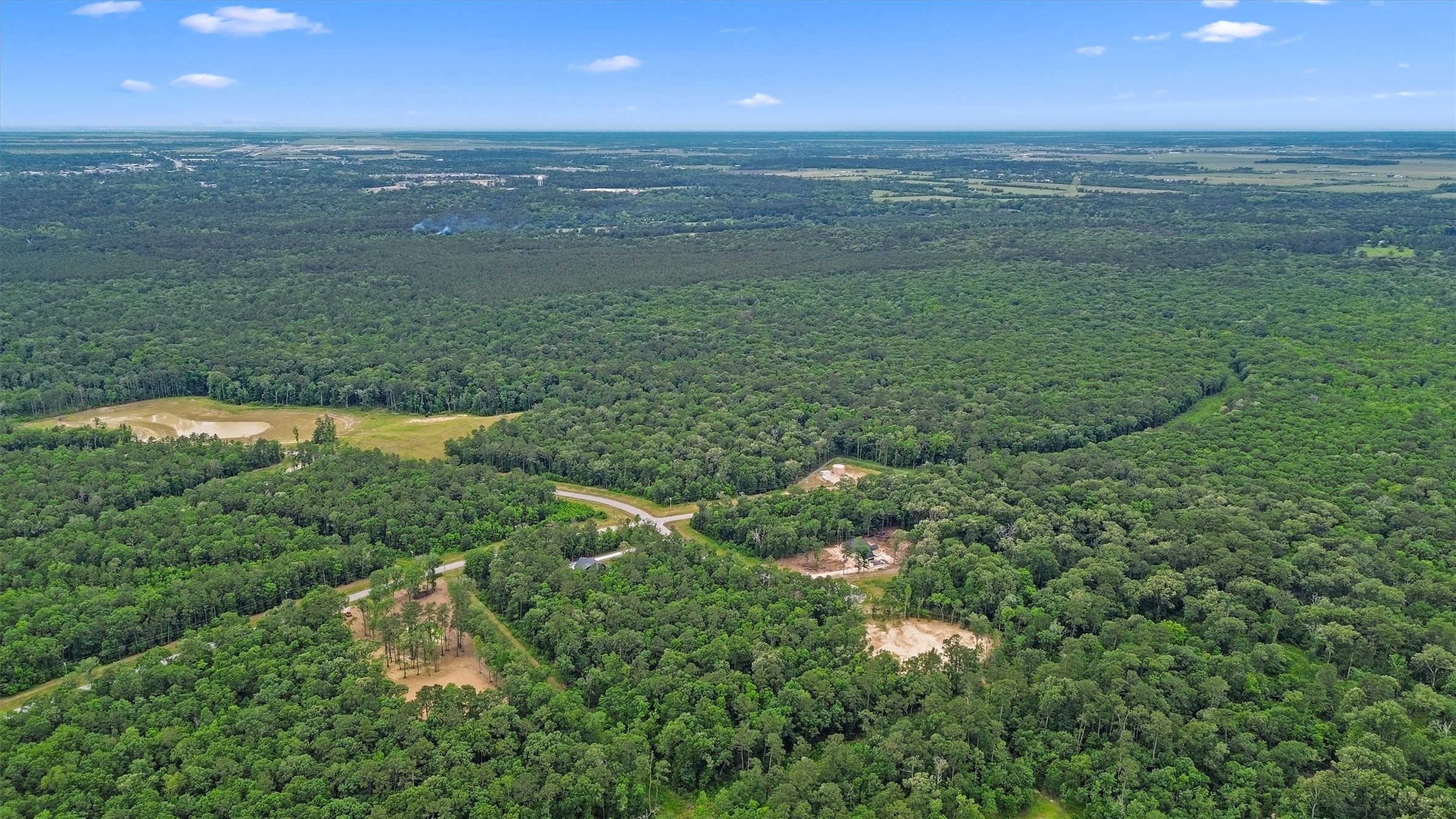 A bird's-eye perspective showcases the low-density, wooded character surrounding White Oak Trails in Liberty County.