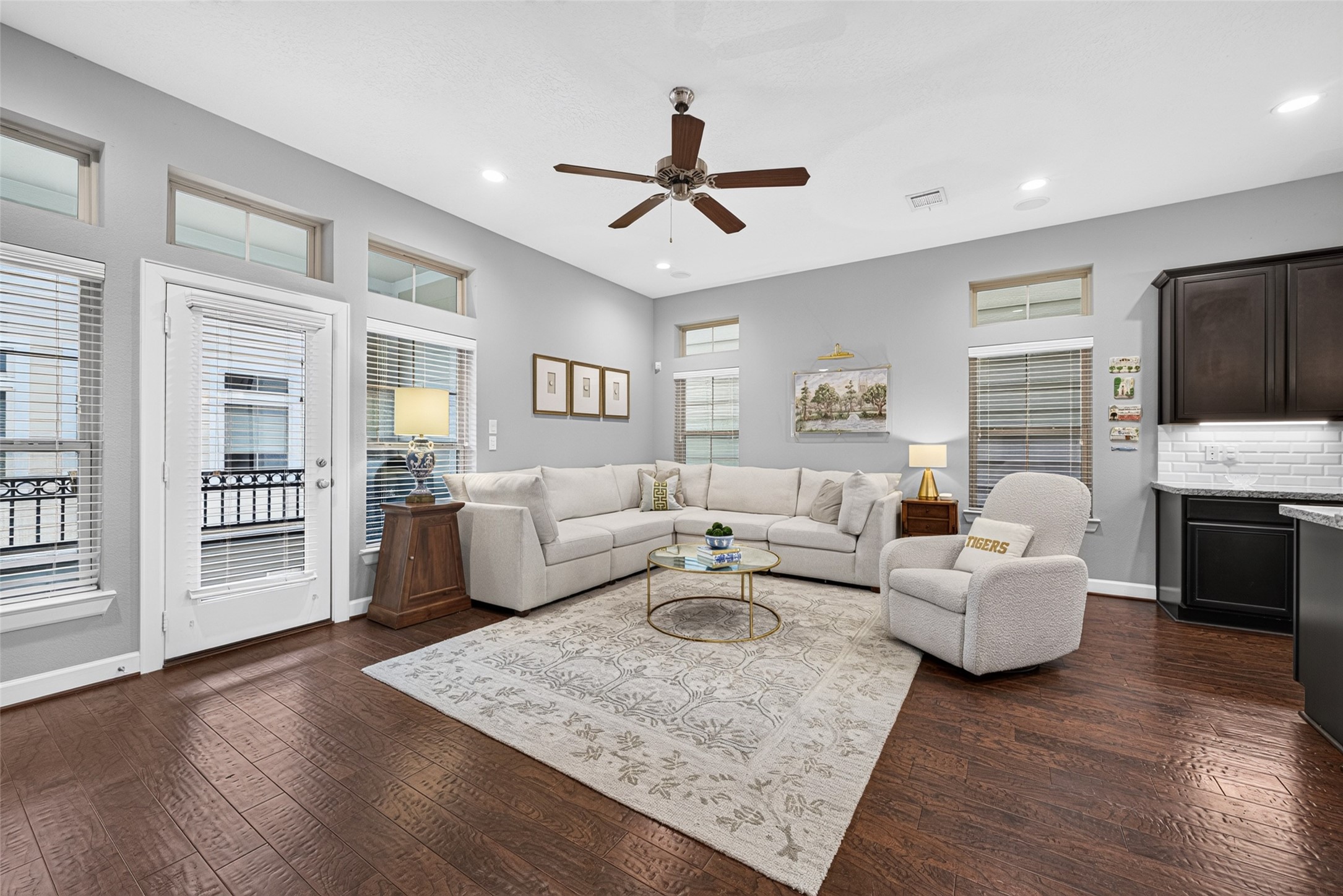 Bright, inviting living room with hardwood floors, recessed lighting, and French doors leading outdoors.