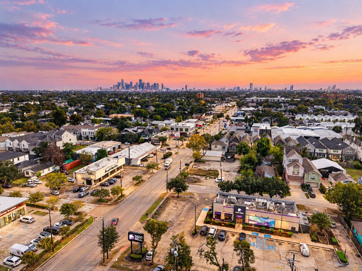 Beautiful aerial view showcasing the surrounding neighborhood, nearby dining and shopping, and the Houston skyline in the distance.