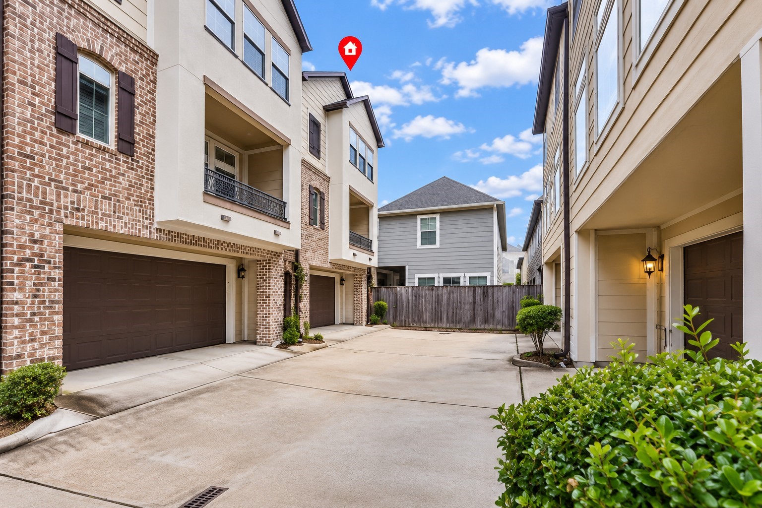 This three-story home features charming brick accents and a covered balcony.