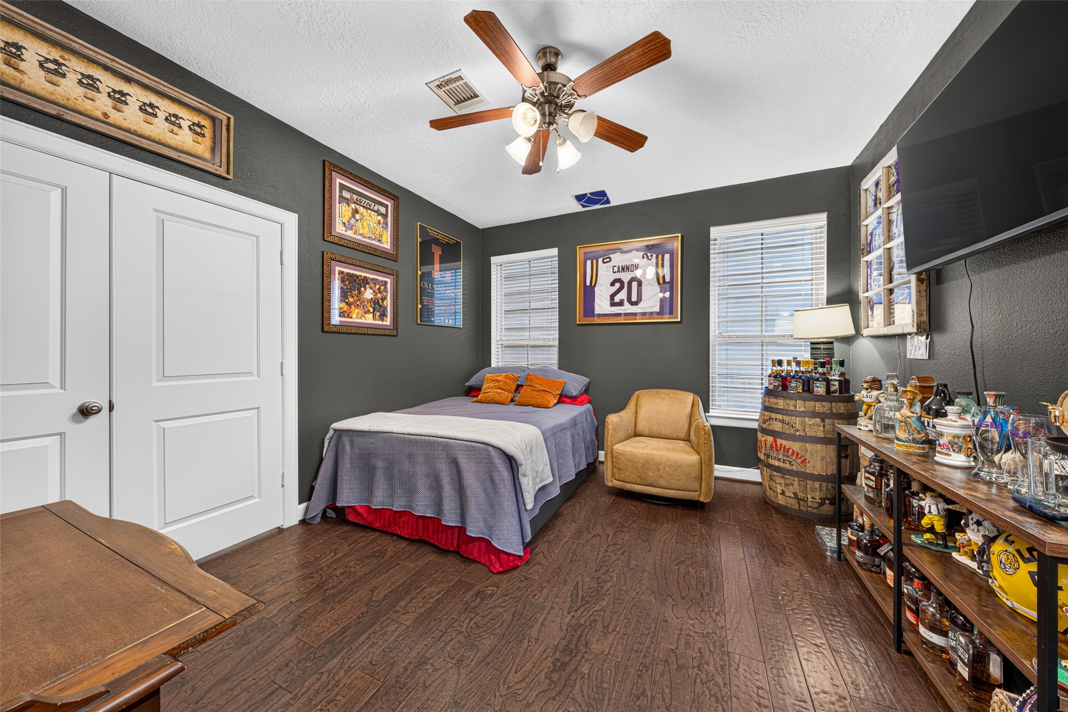 Versatile downstairs guest bedroom with an attached bath, offering flexibility for use as a home office or additional living space.