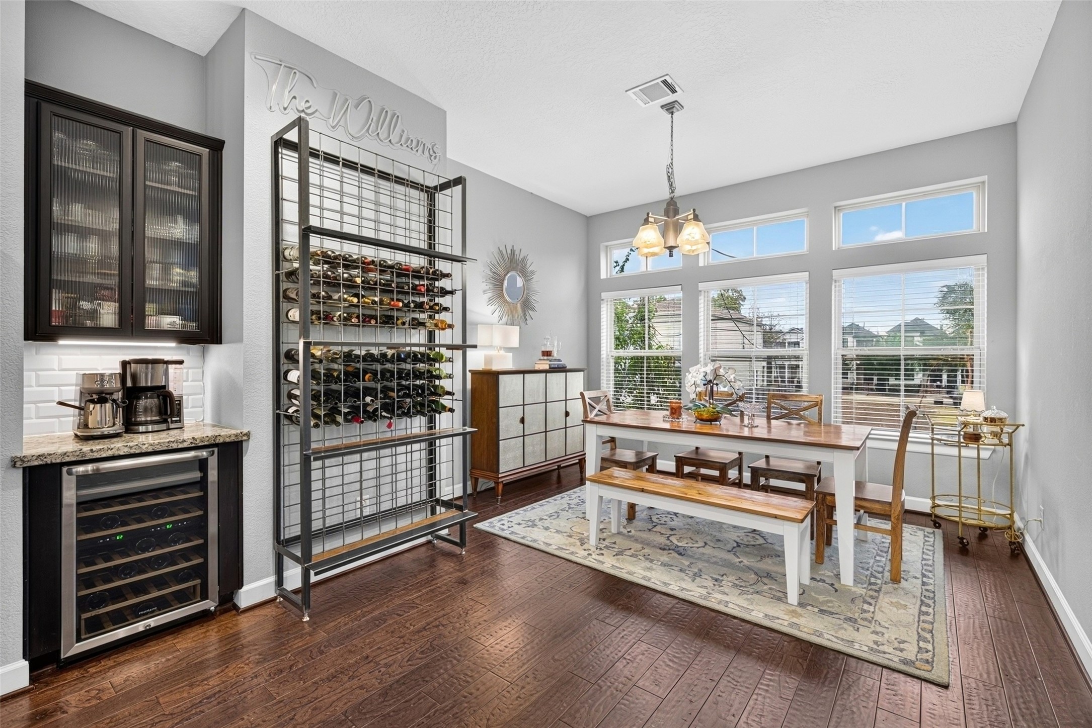 Dining space features large windows, built-in cabinetry, and wine storage for entertaining.