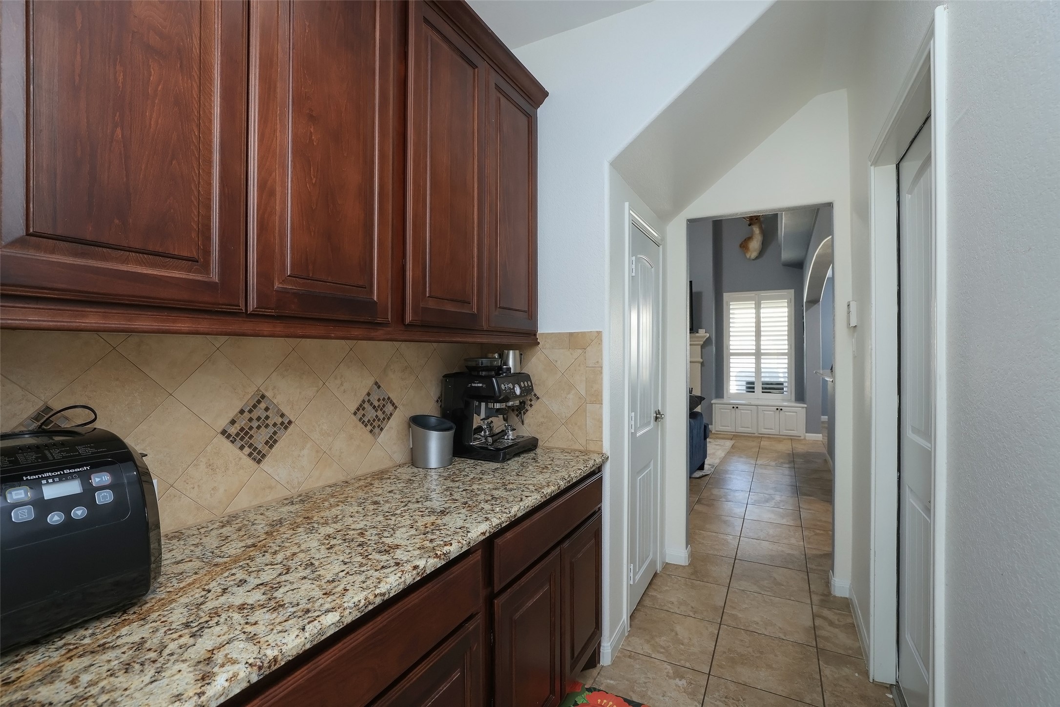 Butlers pantry with storage closet on the left, and garage entry on the right