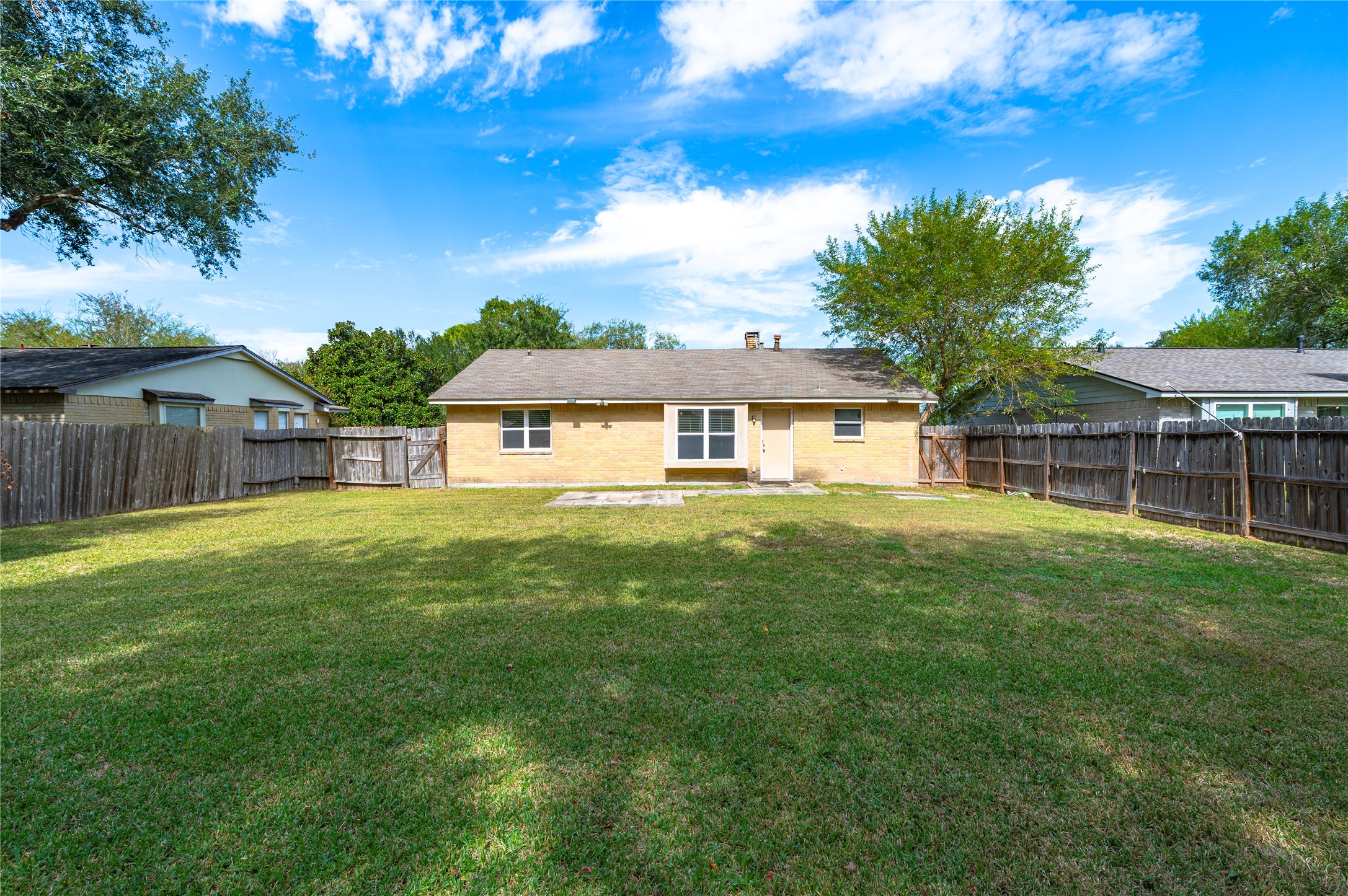 Trees along the back fence give the backyard a great shaded space.