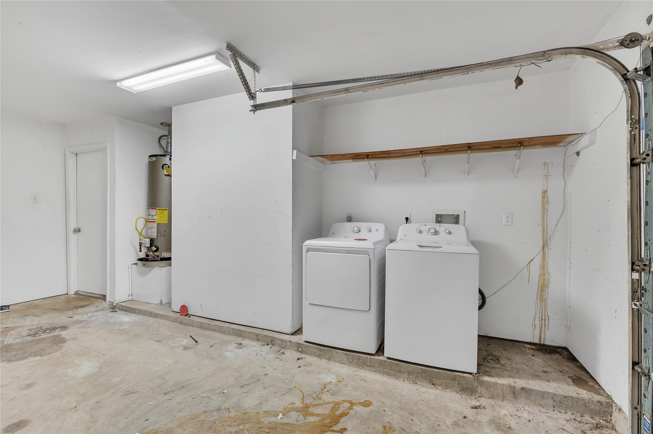 Washer and dryer located in the garage.