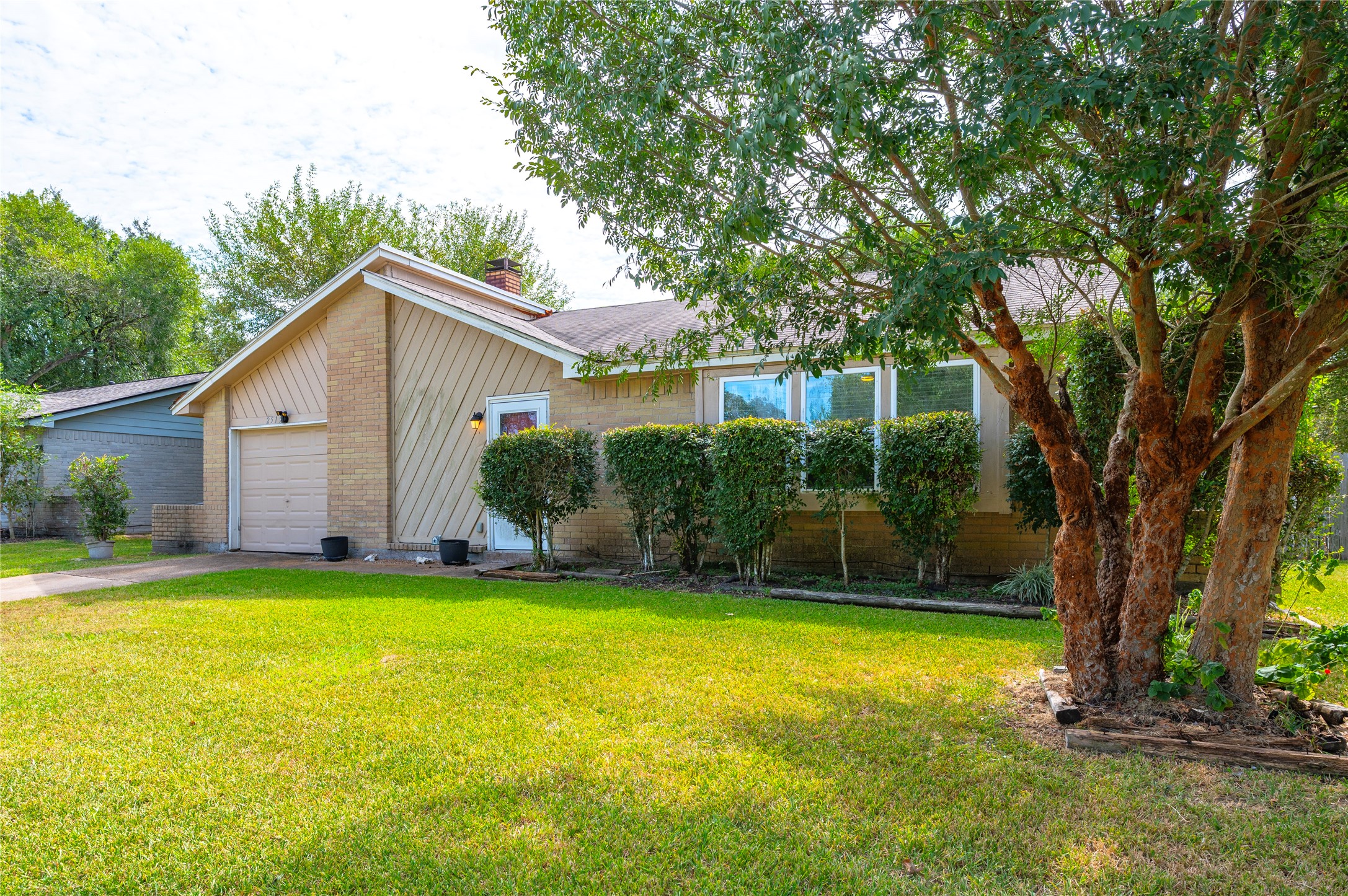 Tree and landscaping give the home curb appeal.