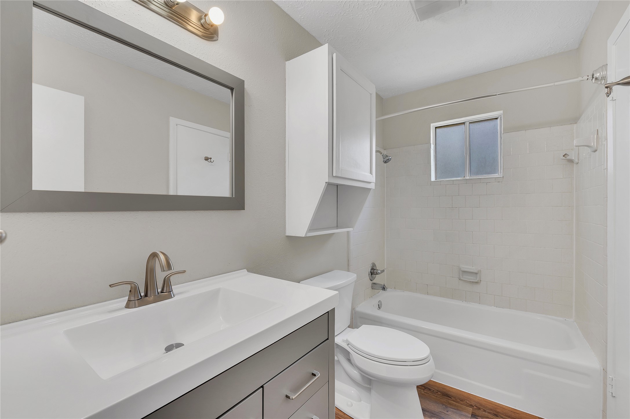 Full sized bath with updated large vanity and shower/tub combo.