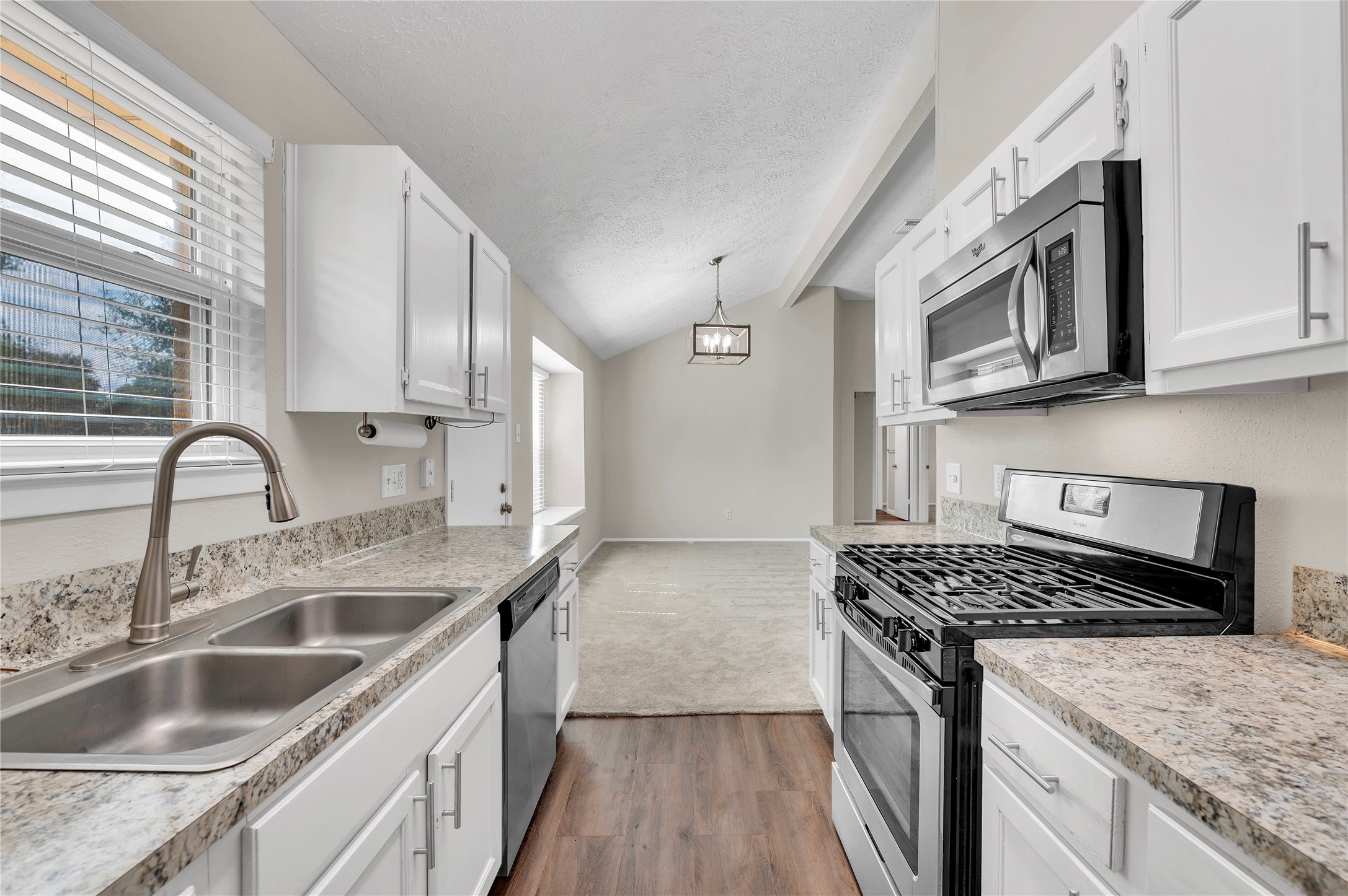 Stainless steel gas range and built in overhead microwave..