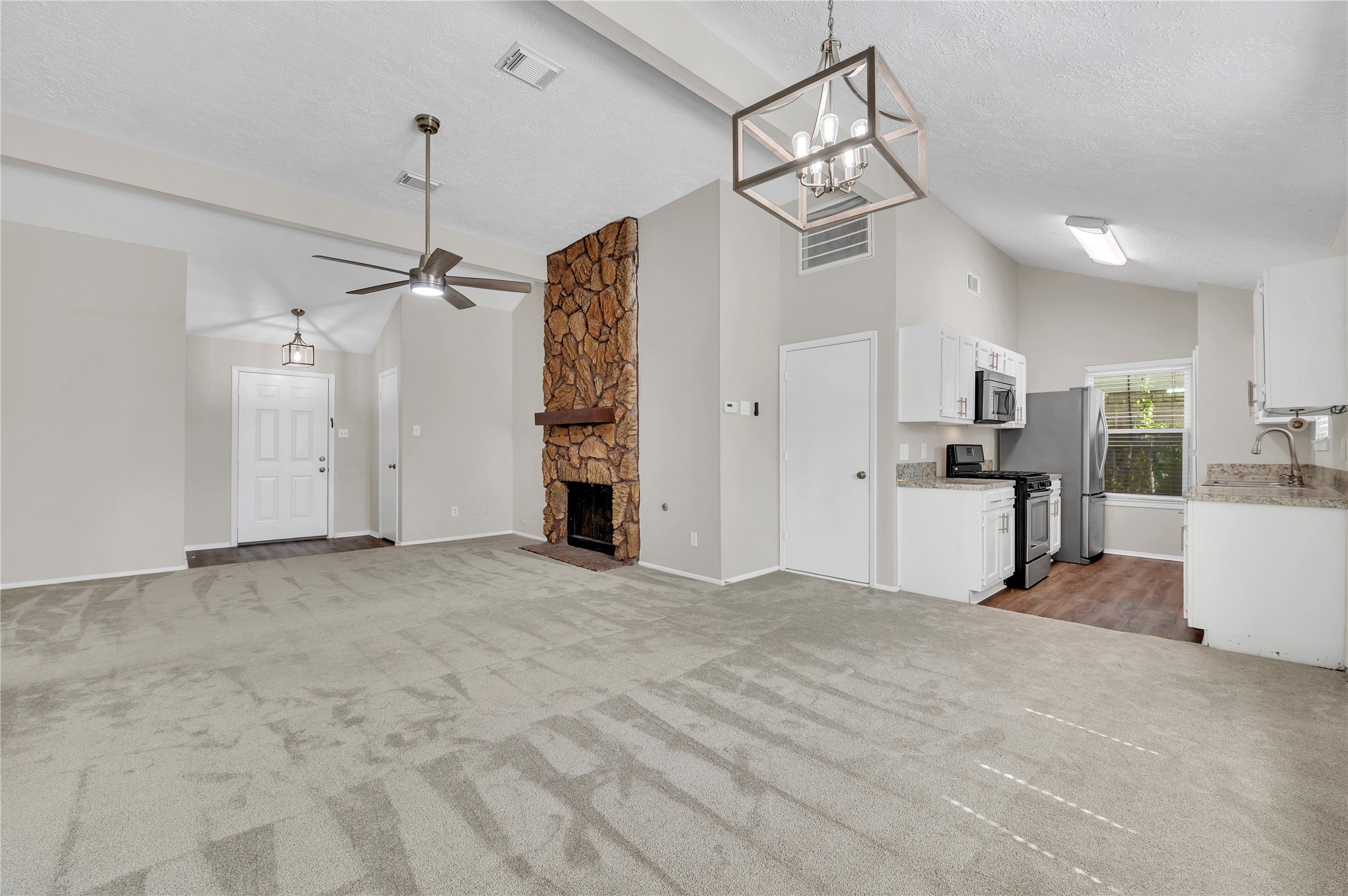 Another view of the large open floor plan.  Access to garage via door next to kitchen.